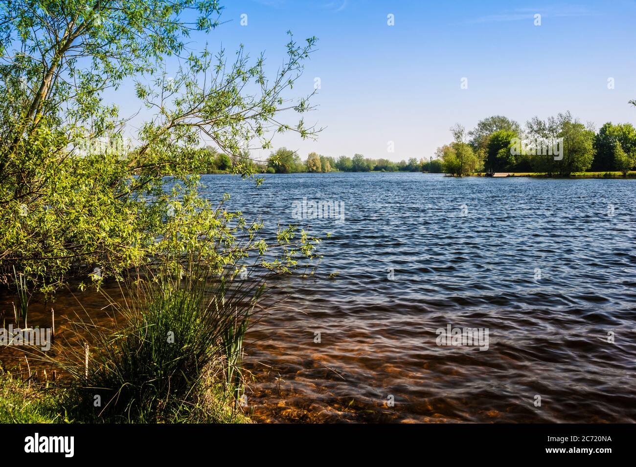 One of the lakes at Cotswold Water Park on a blustery spring day.. Stock Photo