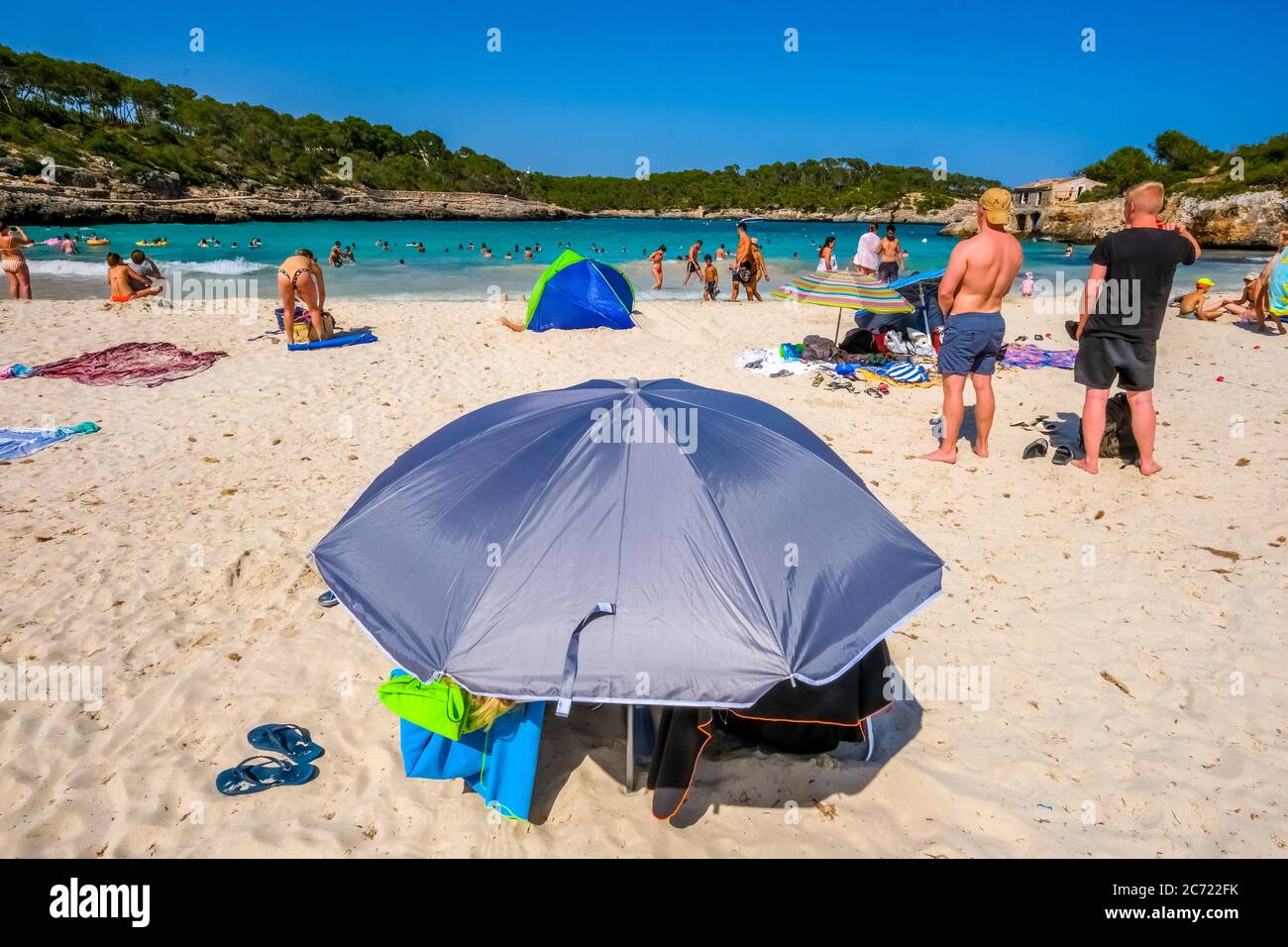 Lonely beach in the Parc Natural de Mondrago and beach S'amador with numerous bathers, who usually keep the minimum distance during the Corona pandemi Stock Photo