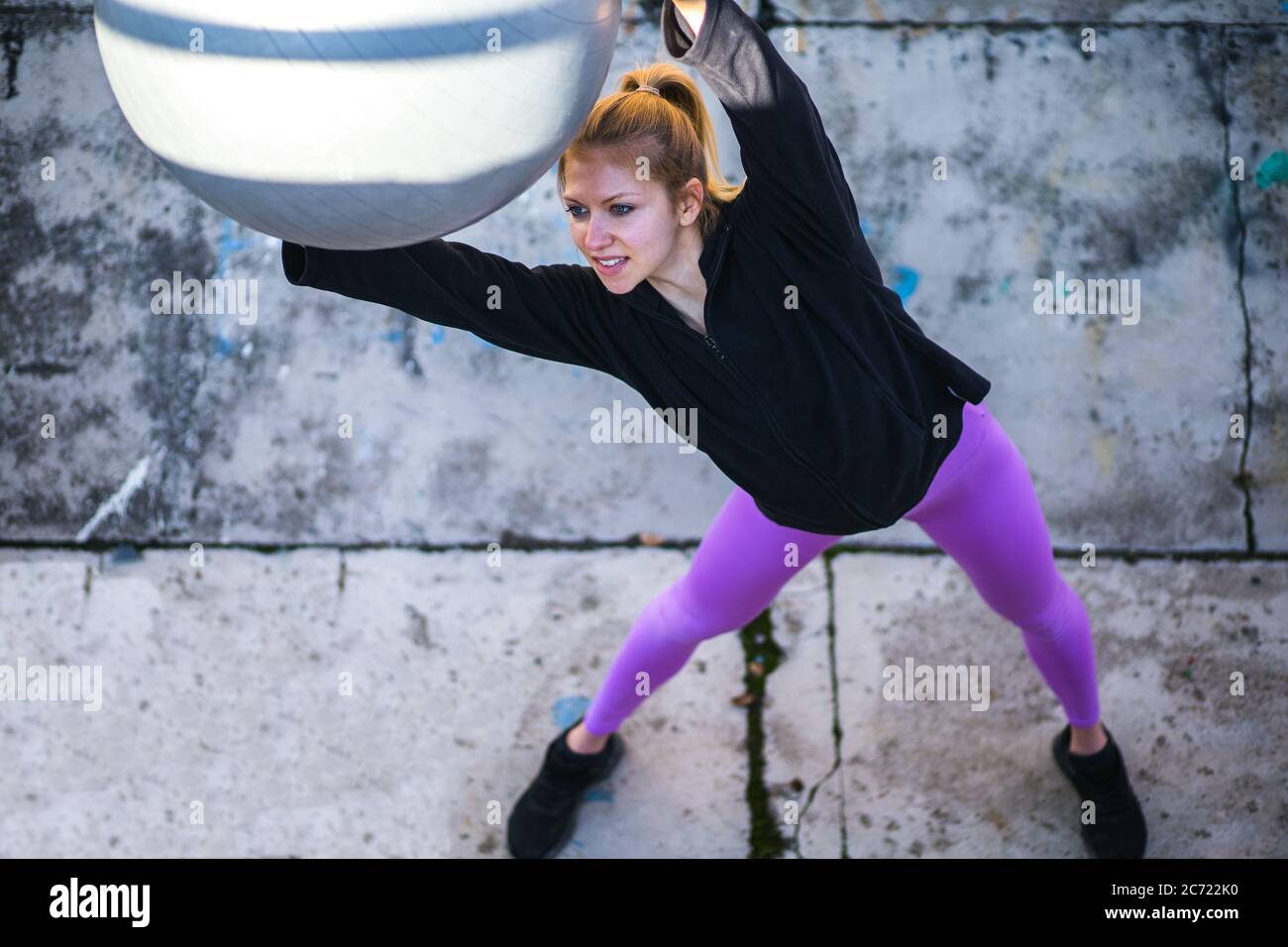 fit young woman doing pilates workout outdoors Stock Photo