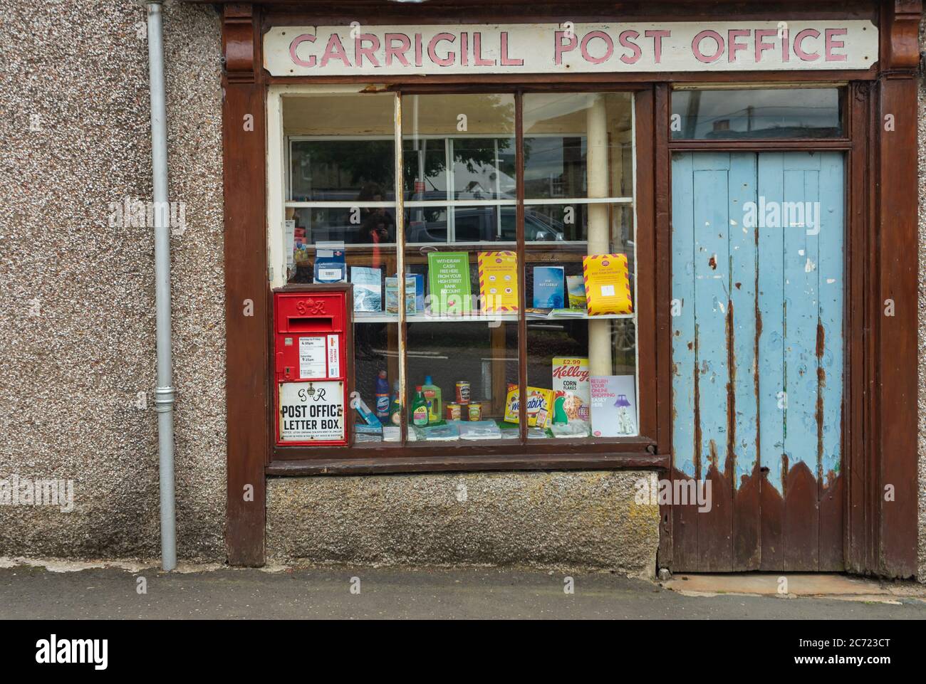 Post Office window at Garrigill with George V postbox, Alston, Cumbria, UK Stock Photo