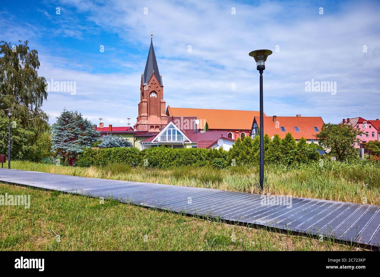 Promenade in Nowe Warpno with church tower in background, Poland. Stock Photo