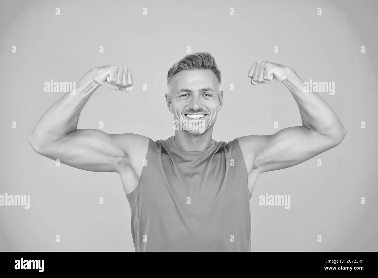 Stay strong in your life. Happy athlete show physical strength. Strong man flex arms blue background. Building strong biceps and triceps. Strong muscle workout. Sport and fitness. Get stronger. Stock Photo