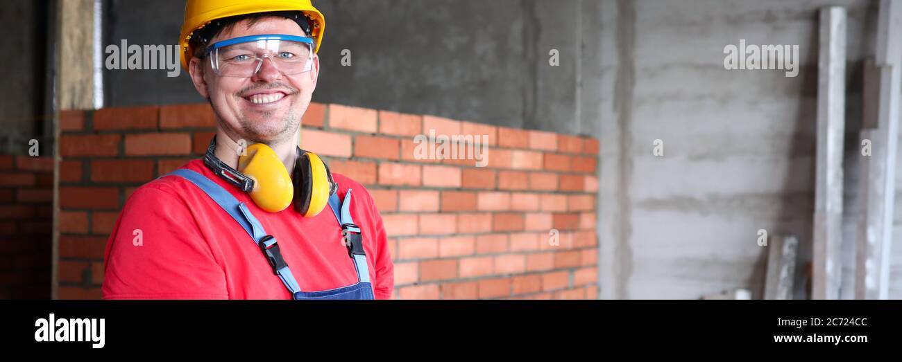 Smiling builder writing on clipboard work results Stock Photo