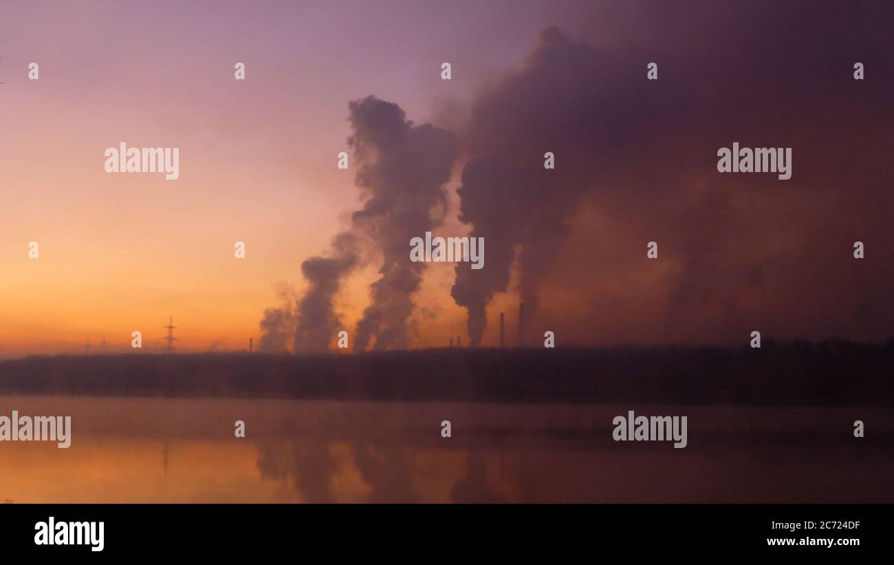 Gas, steam and smoke. Industrial chimneys time lapse. Metallurgical industrial factory. Poisoned air. Epic pollution of nature. Toxic substances. Stock Photo