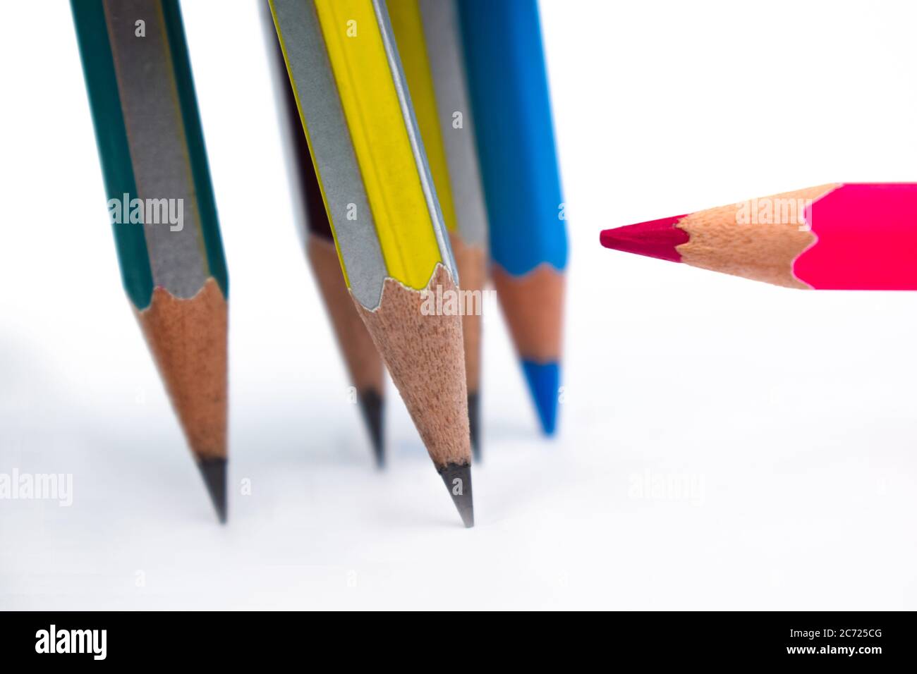 One red colored wood pencil crayon pointing at five different colored
