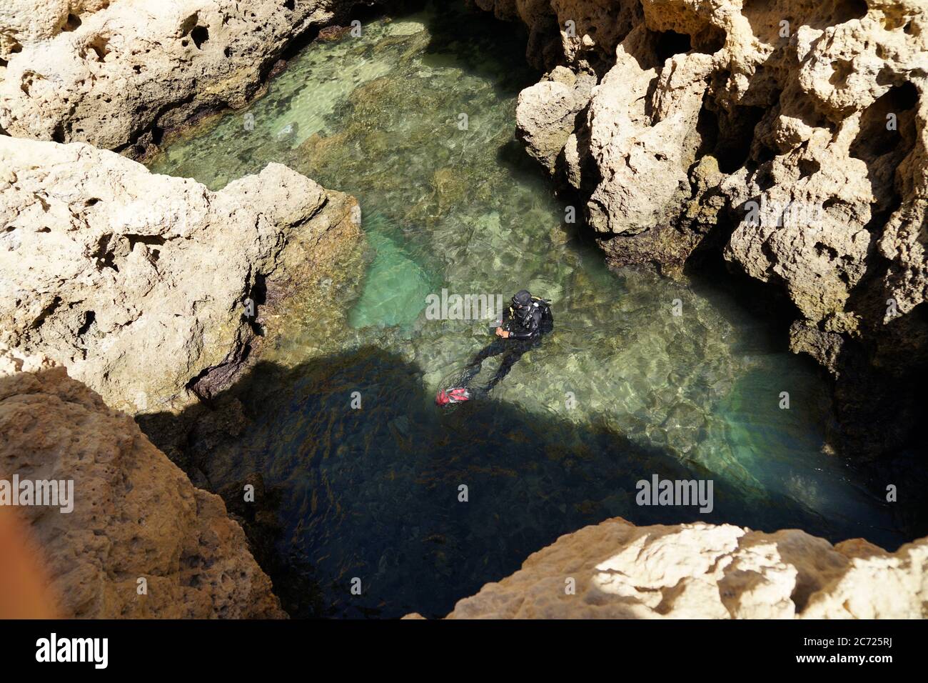 Diver diving between rocks hi-res stock photography and images - Alamy