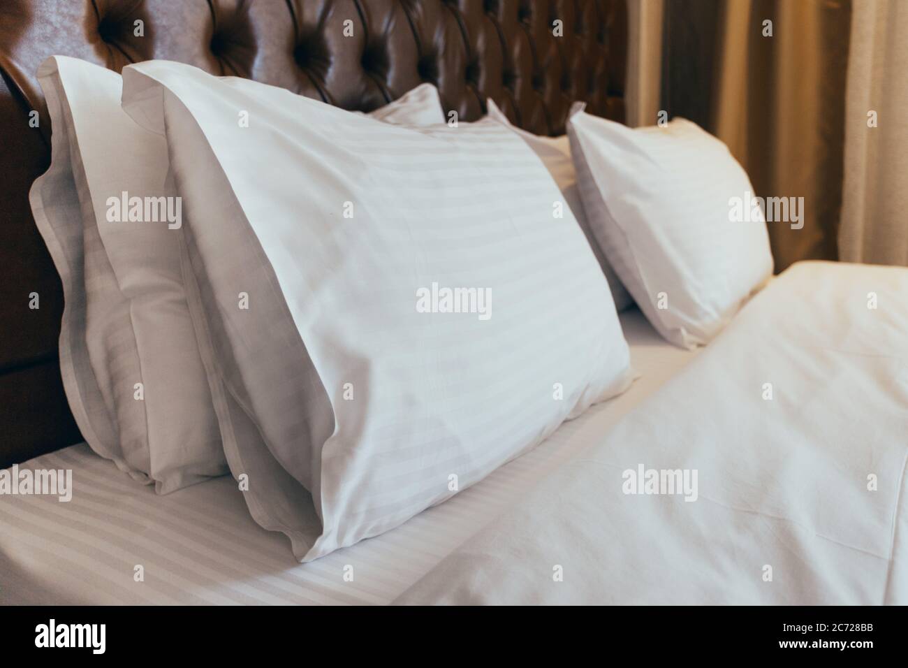 Soft white pillows on comfortable bed, closeup Stock Photo