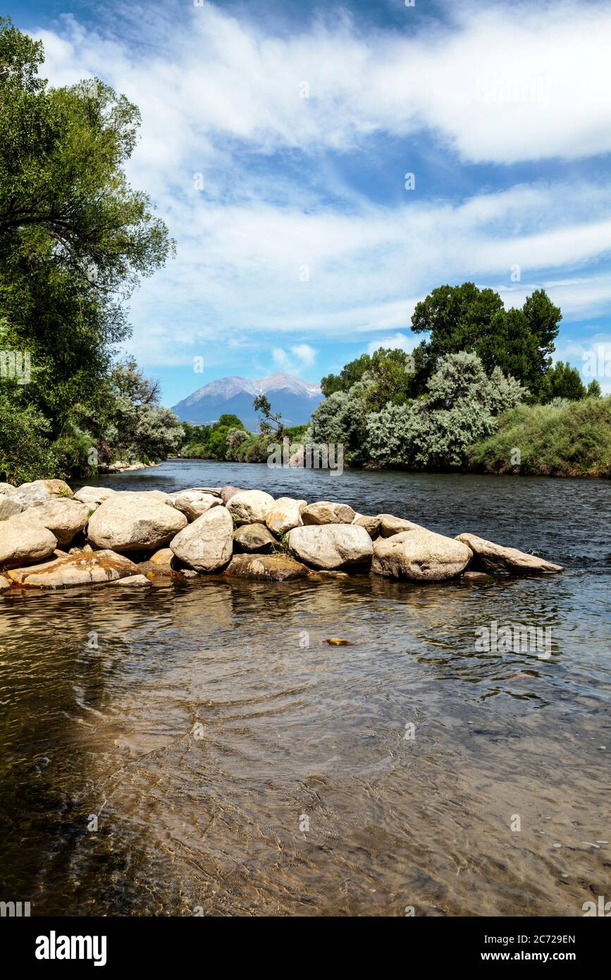 Rocky Mountains in background; Arkansas RIver which runs through the downtown historic district of the small mountain town of Salida, Colorado, USA Stock Photo