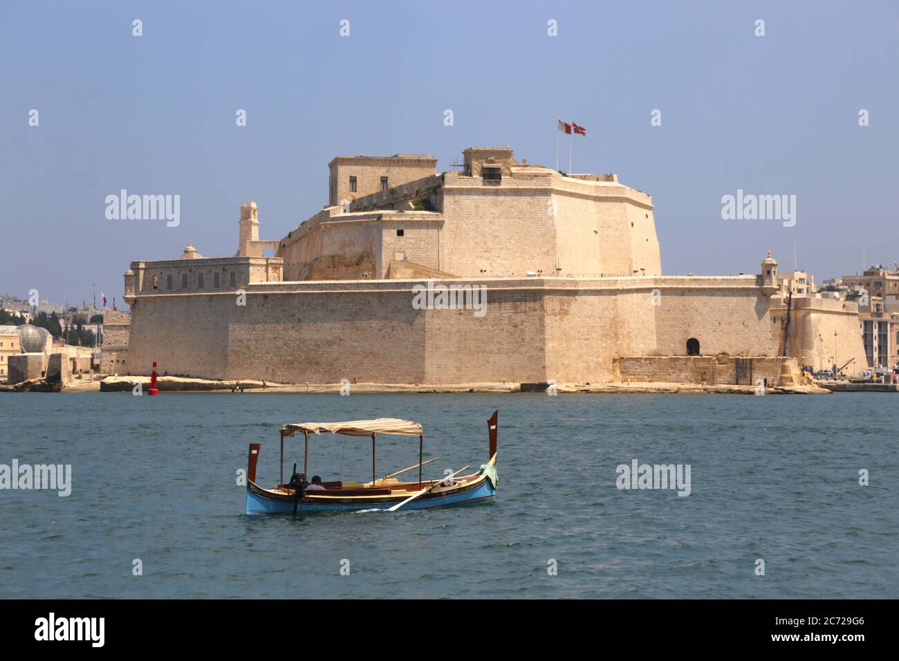 Birgu (Vittoriosa). Malta. Fort San Angelo over the Grand Harbour. Gondola passing by. Stock Photo
