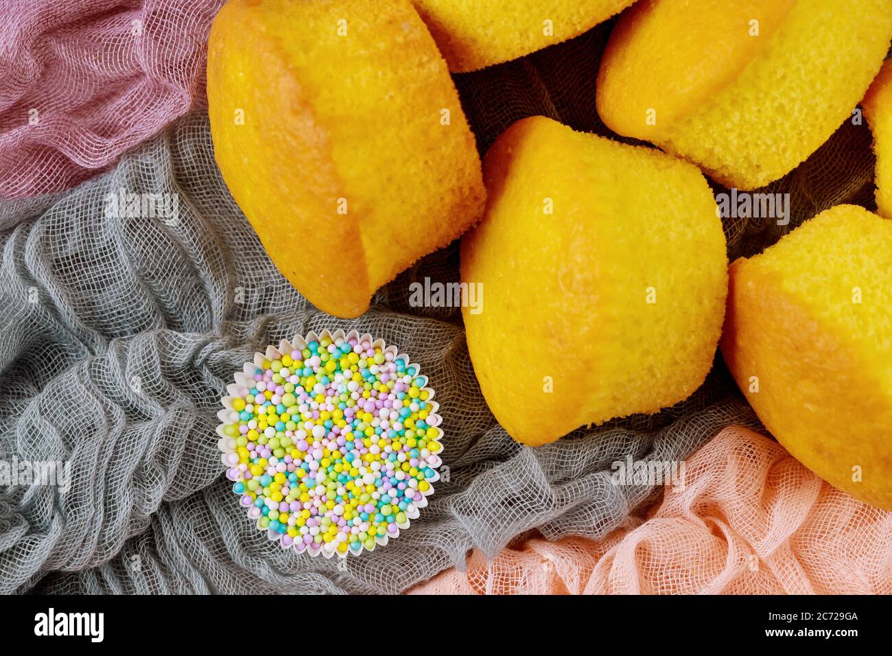 Vanilla plain cupcakes with sugar sprinkles. Close up. Stock Photo