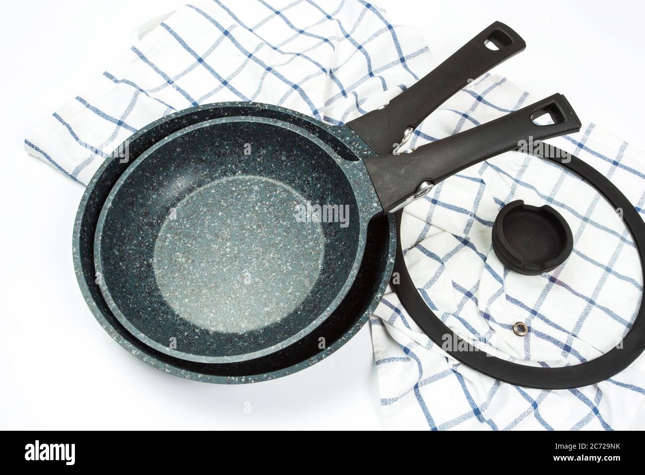 Photo of a ceramic frying pan and cover isolated on a white background