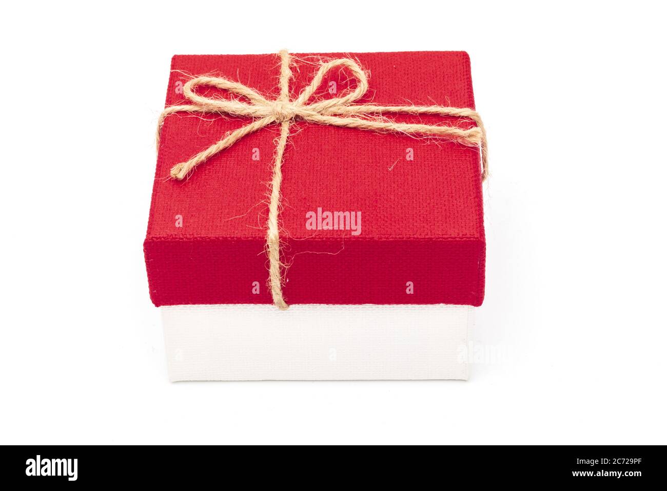 Red gift box tied with a rope tied into a bow isolated on a white ...