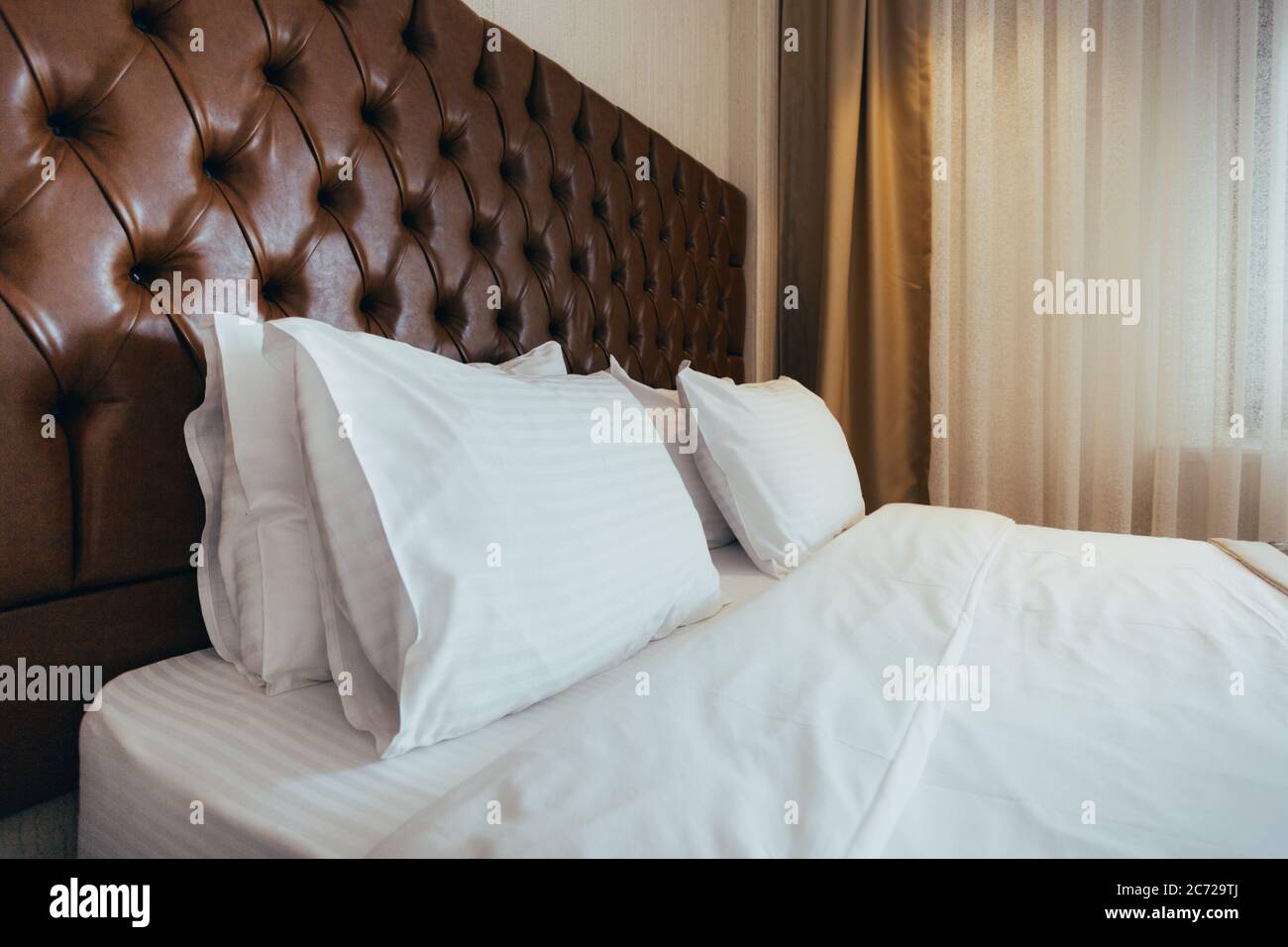 Soft white pillows on comfortable bed, closeup Stock Photo