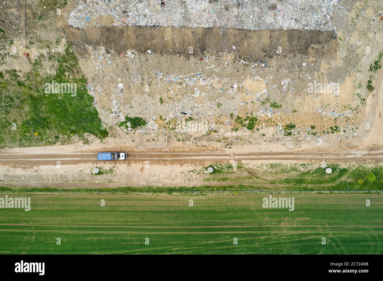 Garbage pile in trash dump or landfill. Dump trucks and excavators unloading waste. Stock Photo