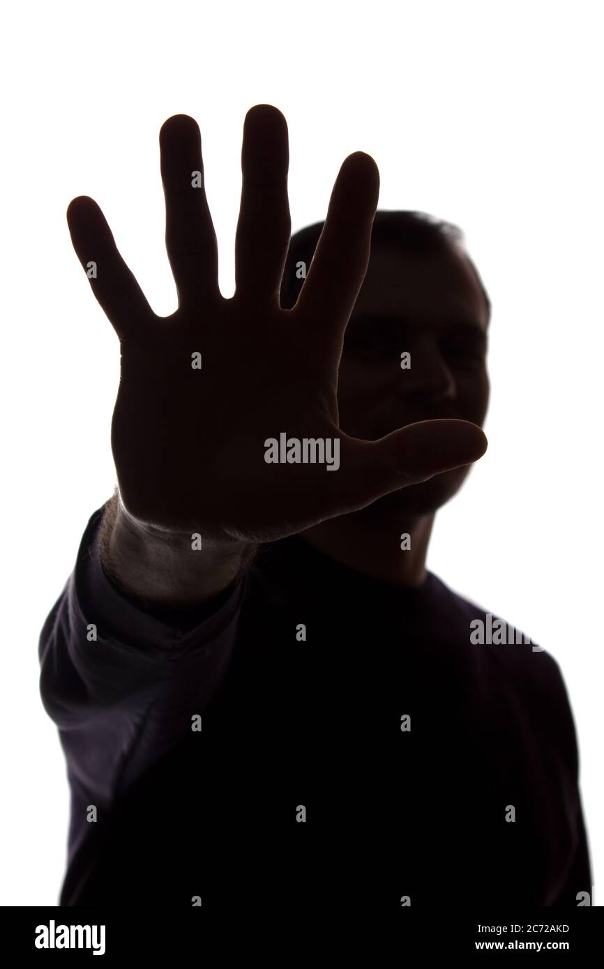 The hand of a young man covers his face, protest - silhouette, concept ...