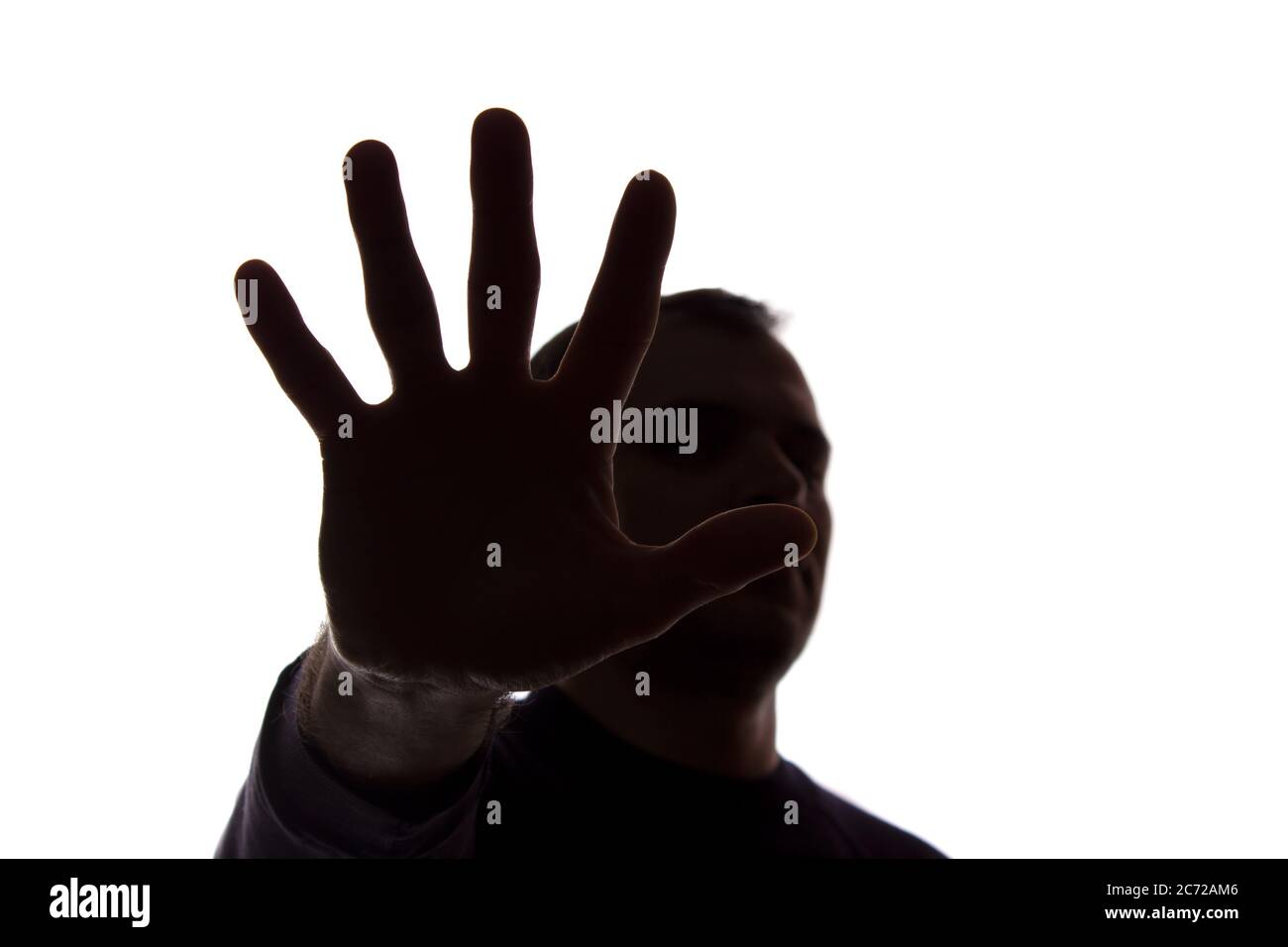 The hand of a young man covers his face, protest - silhouette, concept ...