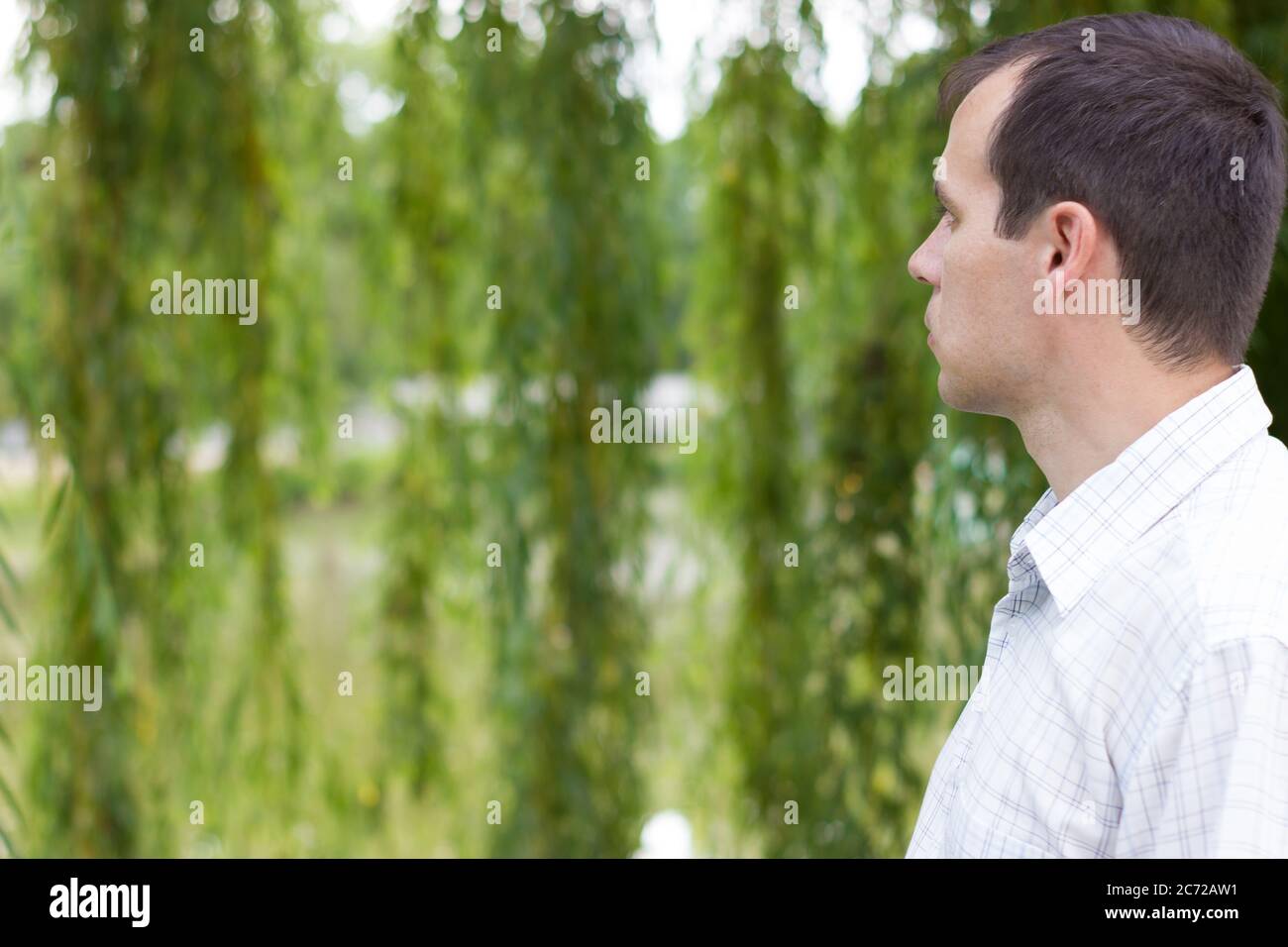 Portrait of a young man, view from the back on nature Stock Photo