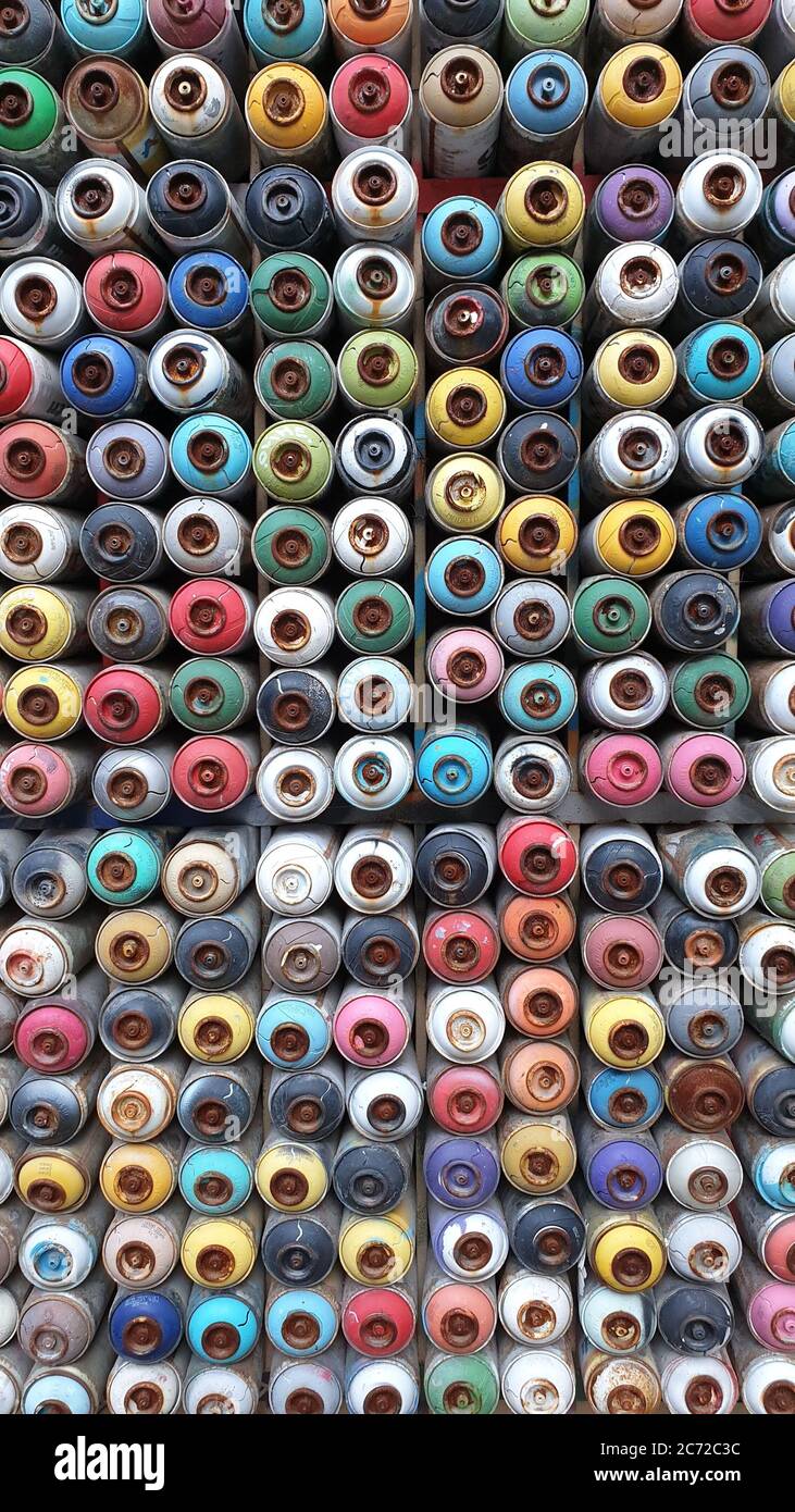 Wall of colored spray cans stacked together Stock Photo - Alamy