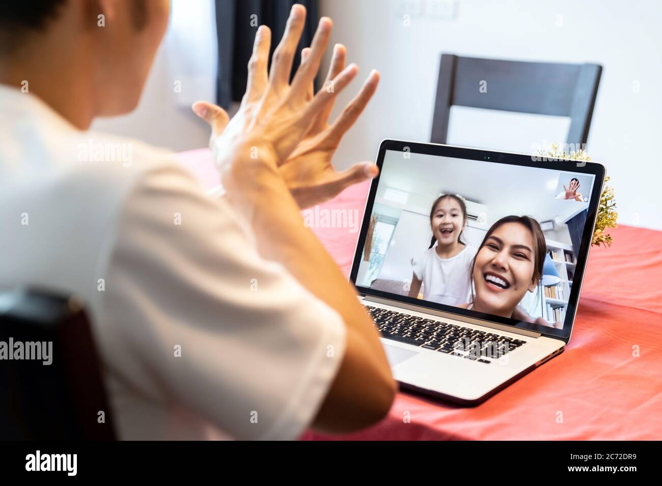 Quarantine father video conference call with his family of mom and daughter while stay in state quarantine. Technology and family reunion new normal w Stock Photo