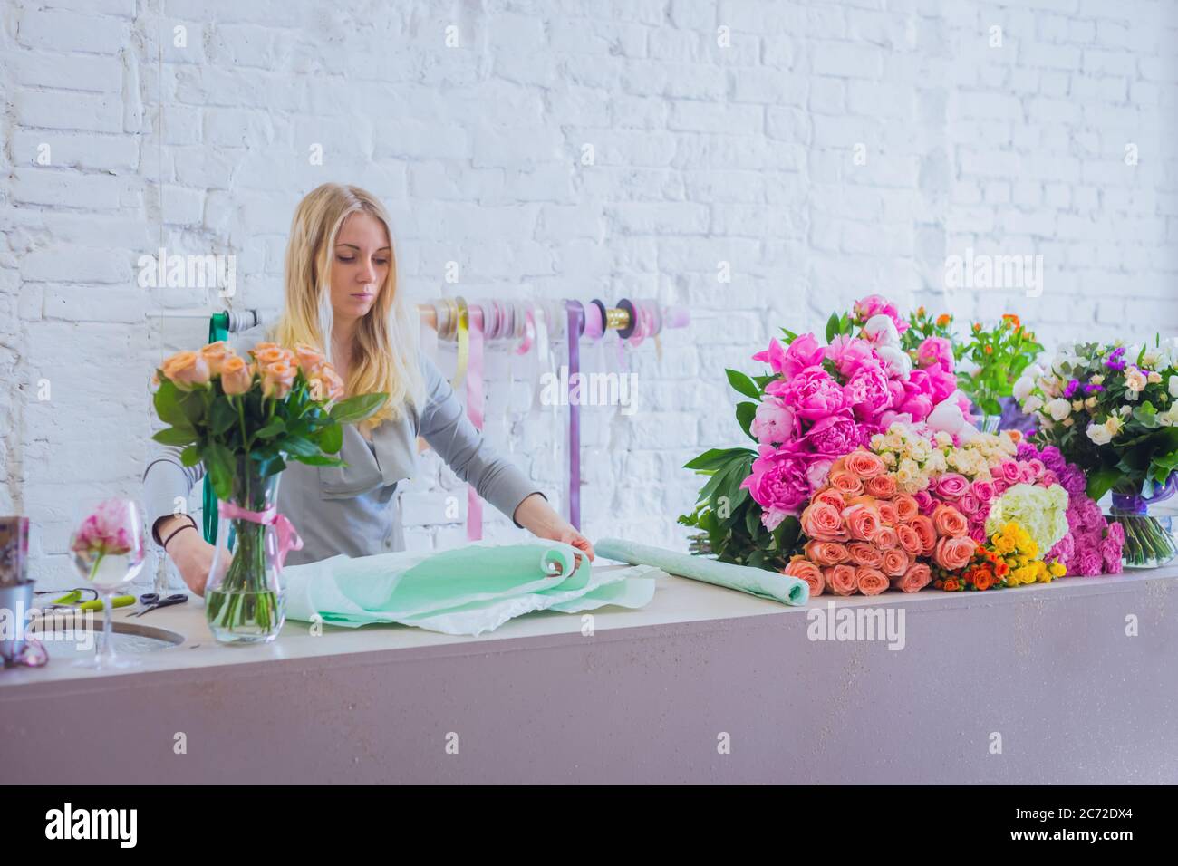 Professional floral artist, florist holding cutter and cutting flower stems  in bright room of flower shop, workshop - close up view. Floristry Stock  Photo - Alamy