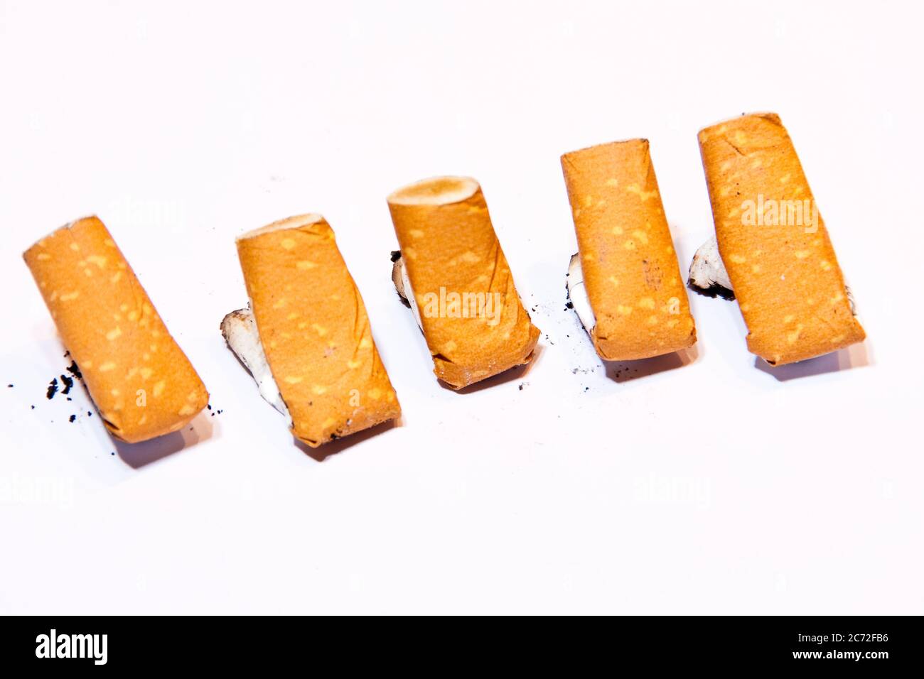 5 cigarette butts on white background Stock Photo