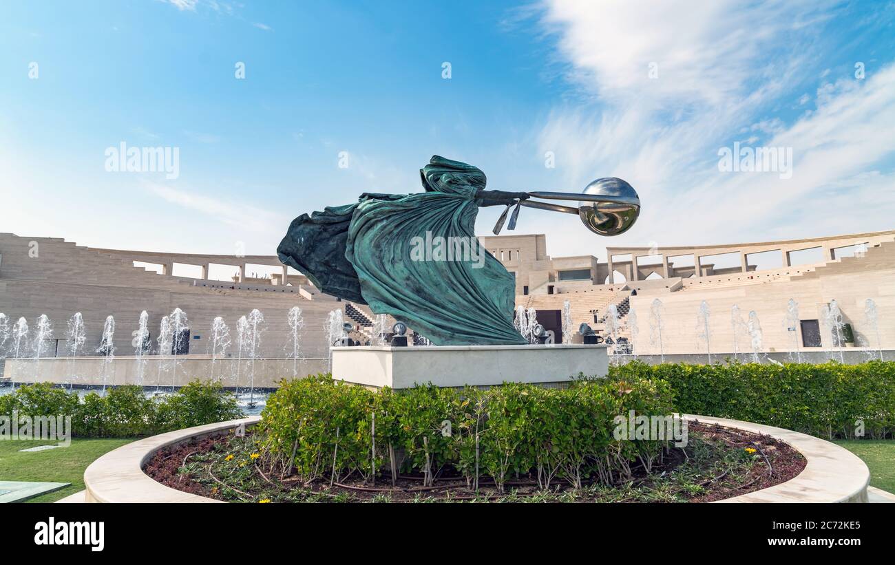 Doha, Qatar- January 2019: Katara Cultural village with statue in foreground and the Amphitheater in the background Stock Photo