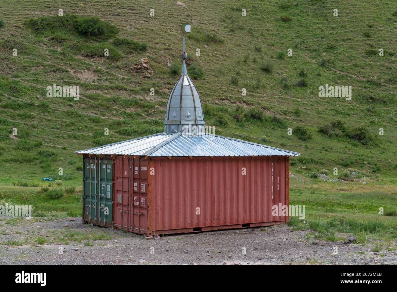 Small mosque made from two containers next to a high altitude road in Kyrgyzstan Stock Photo