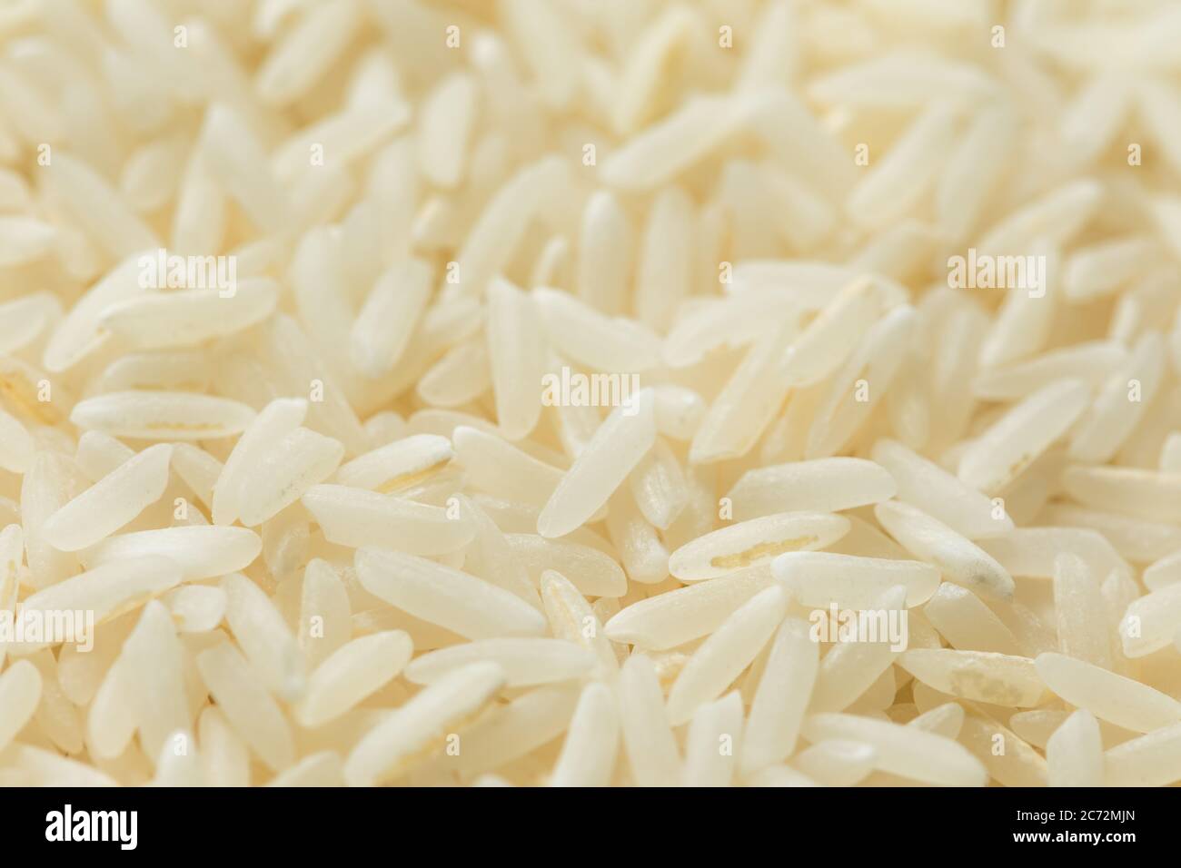 Dry White Long Grain Jasmine Rice in a Spoon Stock Photo Alamy