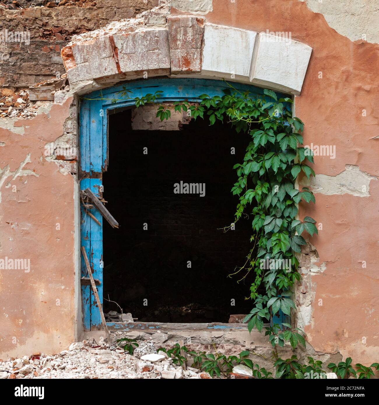 Close up of old damaged abandoned house. Window without glass. Stock Photo