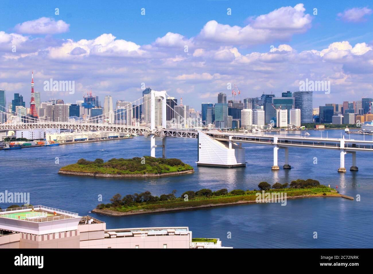 Panoramic view of Odaiba with Rainbow Bridge. Odaiba is a man-made island in Tokyo Bay and a popular entertainment and shopping district. Stock Photo