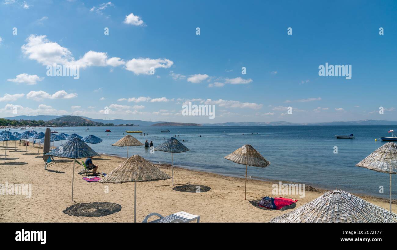 Balikesir, Erdek, Turkey - July 2019: Beach of Erdek with people under the sun and swimming in the Marmara sea. Stock Photo