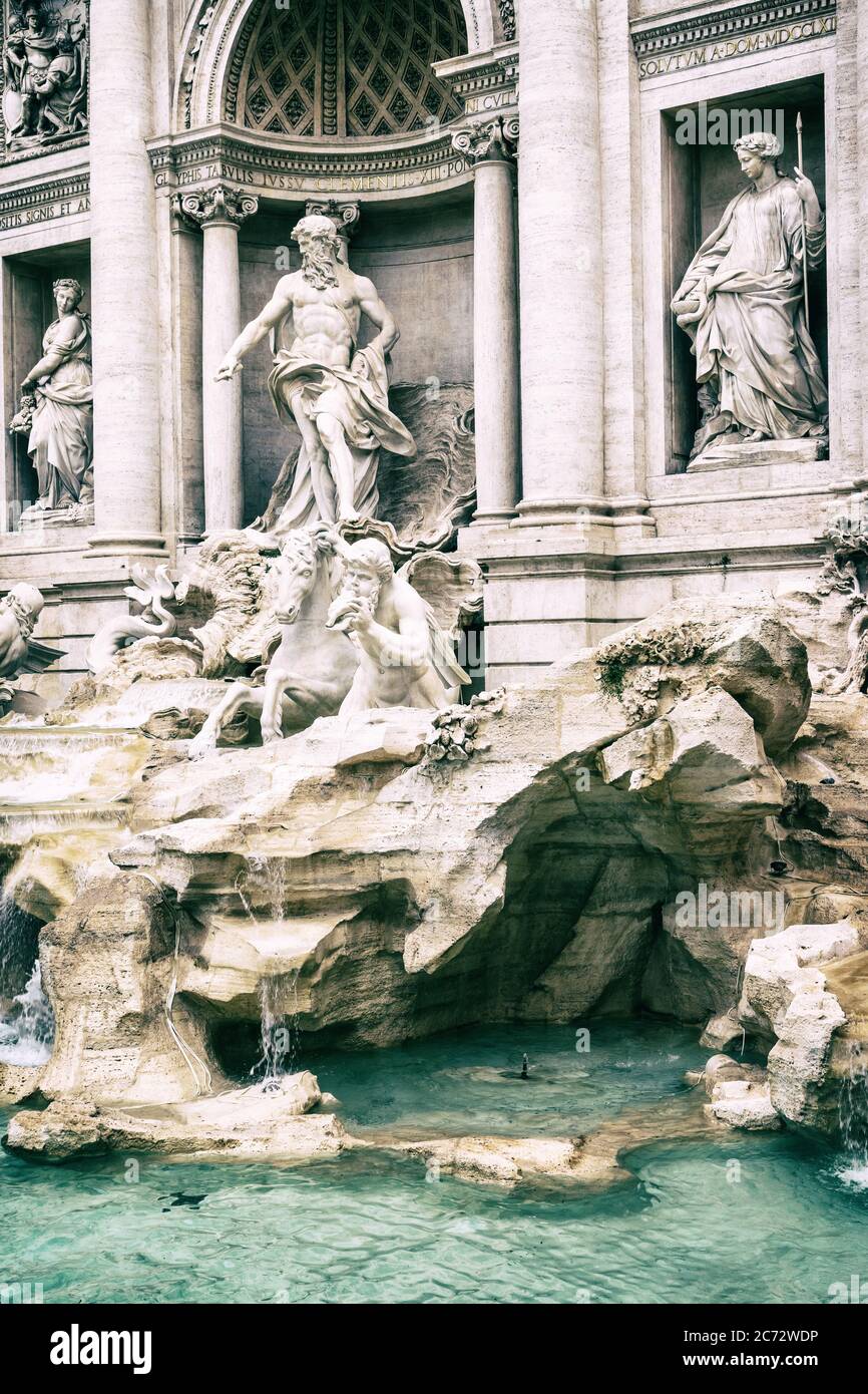 Side view of the statues of the Trevi Fountain in Rome. Italy. Vertically. Edited as a vintage photo. Stock Photo