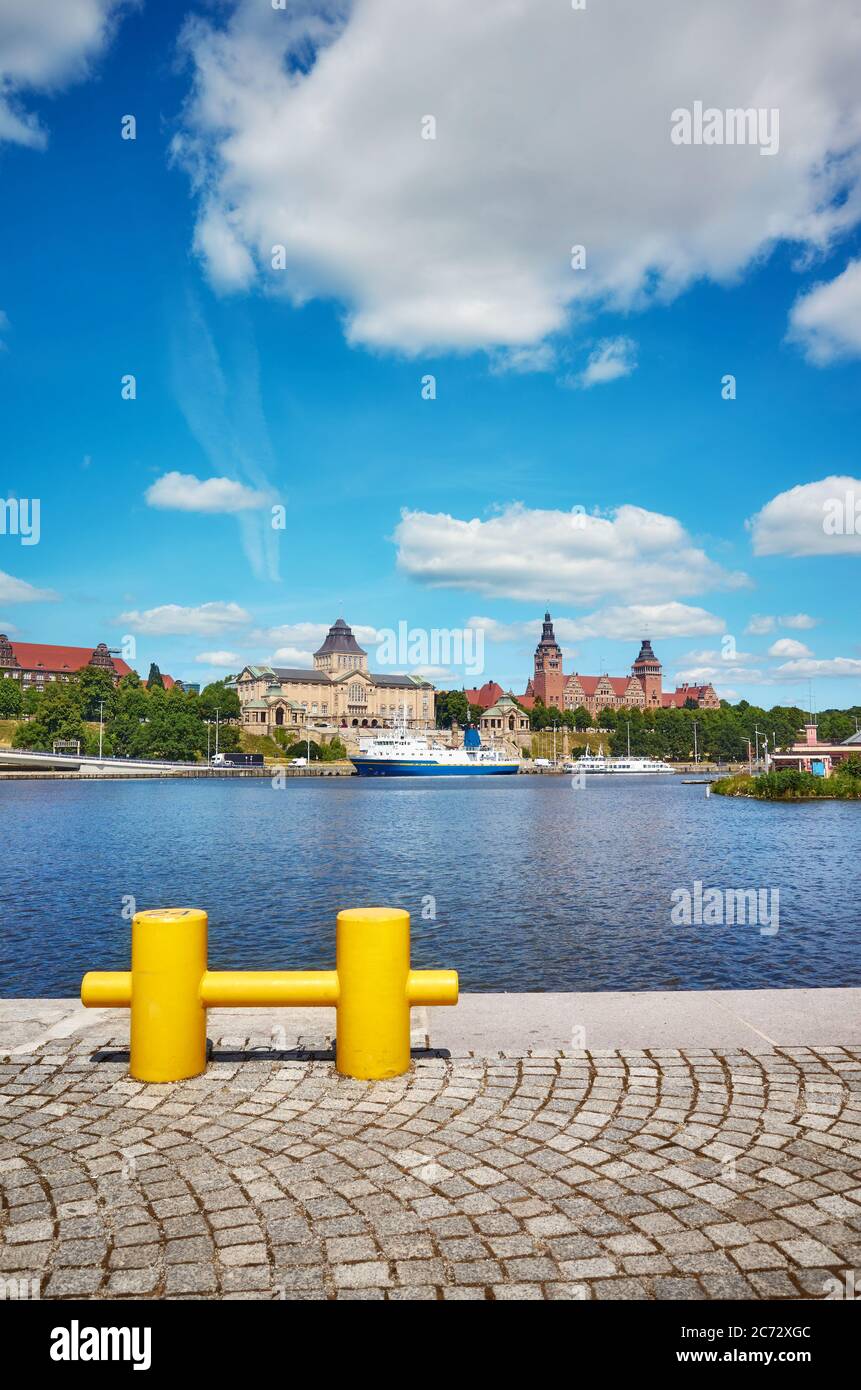 Szczecin waterfront with yellow mooring bollard in foreground, Poland. Stock Photo