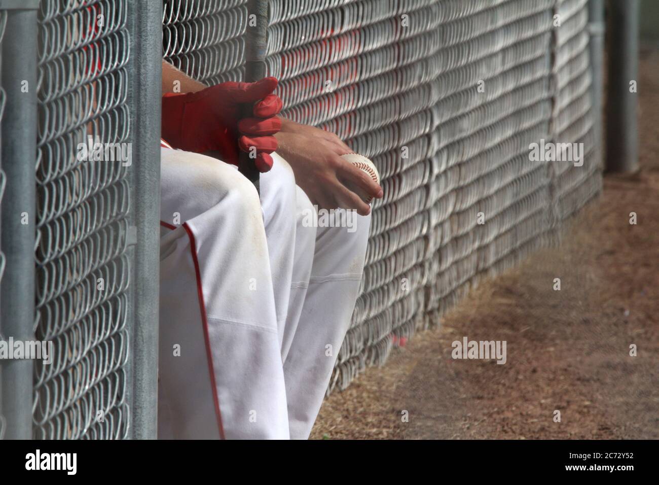 Two baseball players sit on the bench waiting for the game Stock Photo