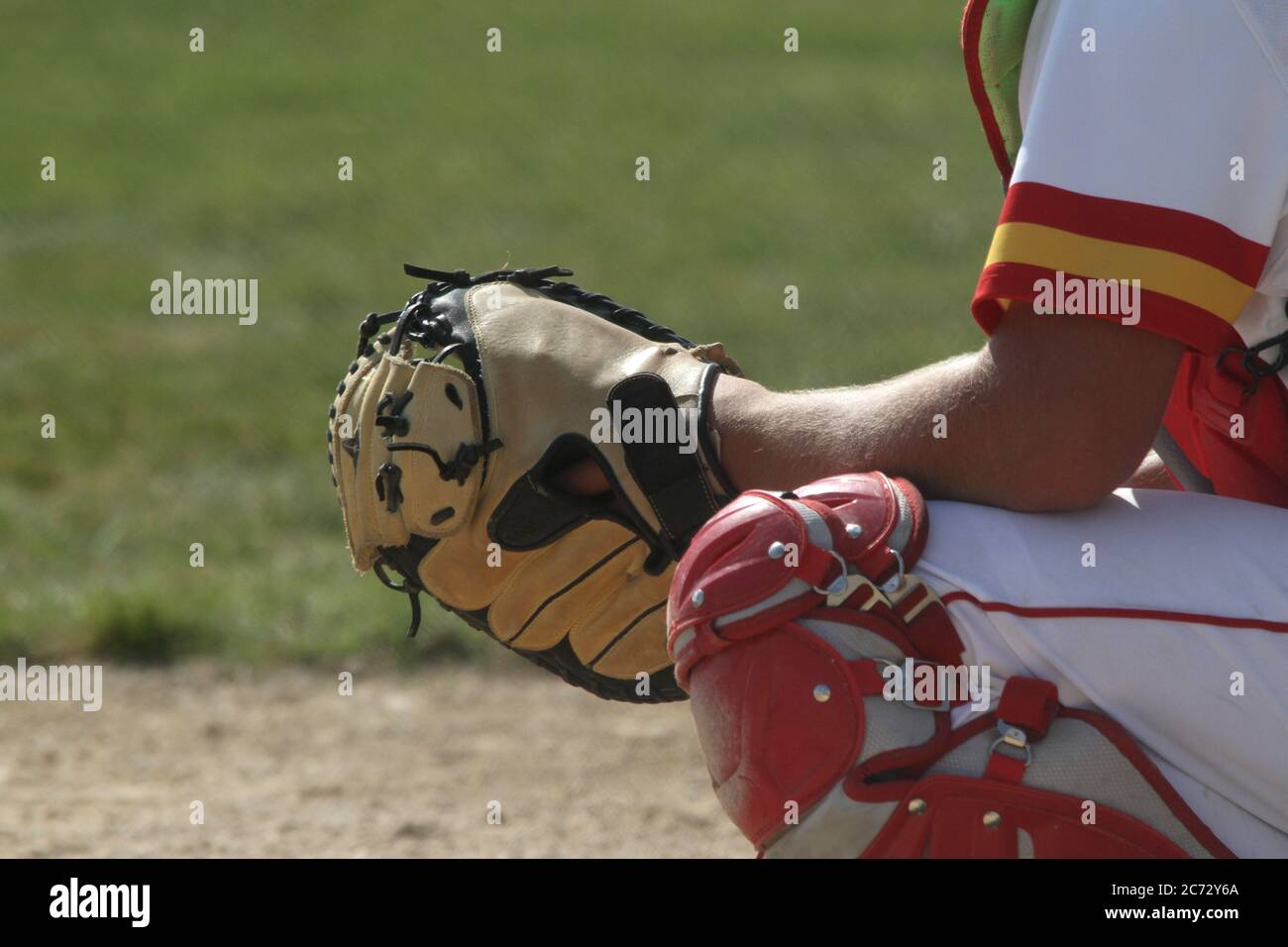 A baseball catcher is ready to receive a pitch. Room for copy on the left side of the frame. Stock Photo