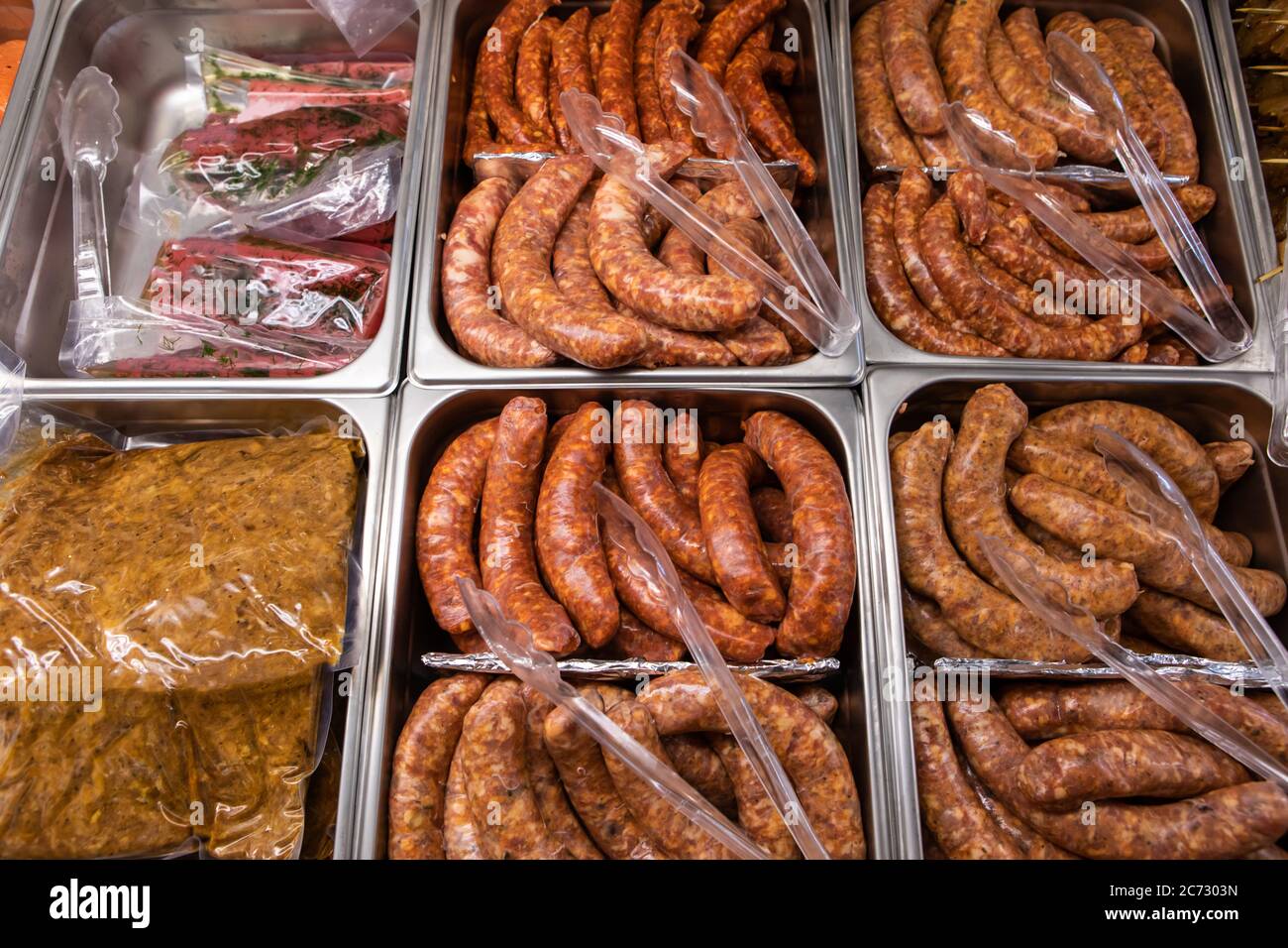 Variety of fresh sausage and meat products on the butcher display