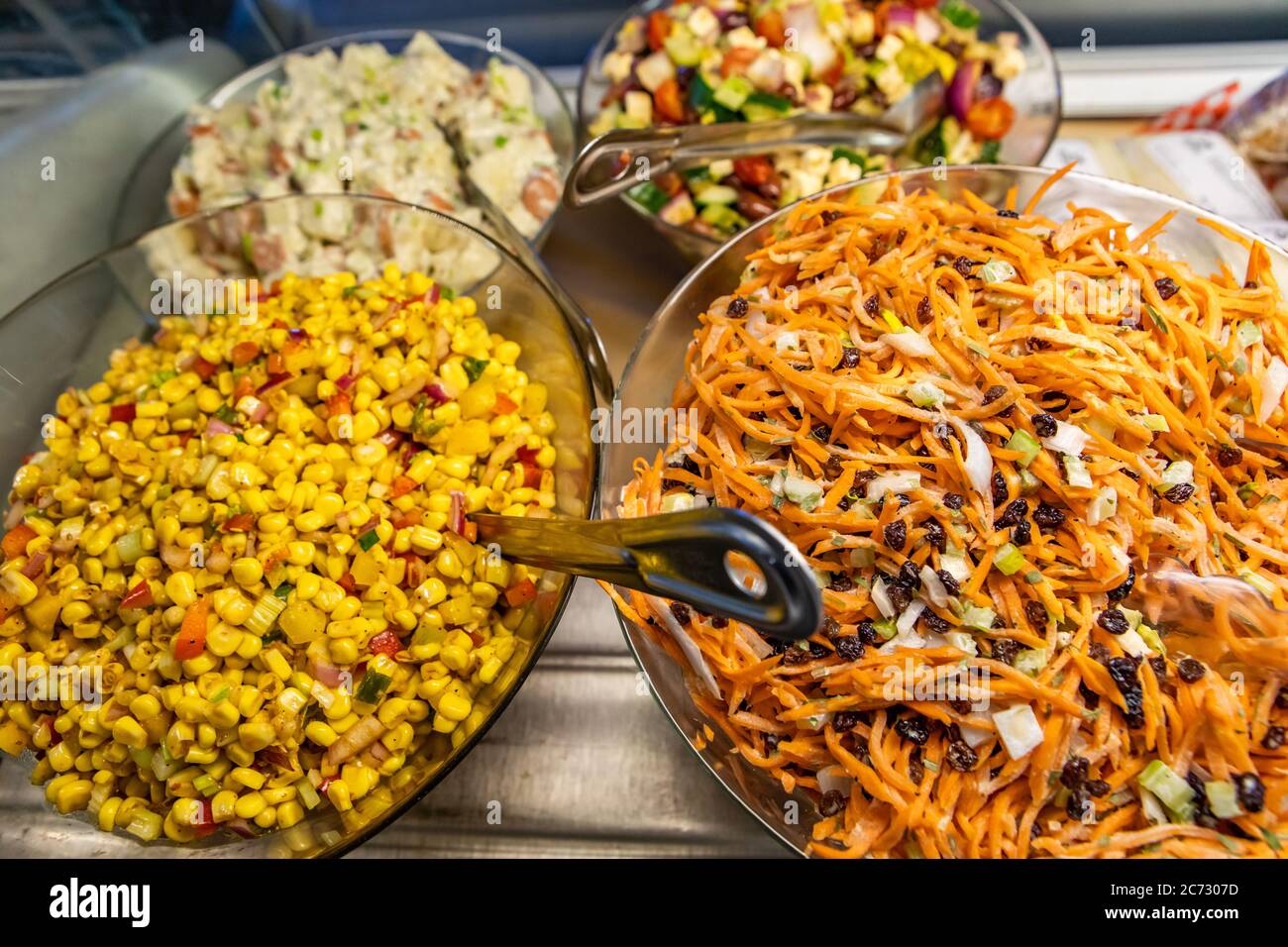 Variety of healthy and delicious salad dishes on display refrigerator