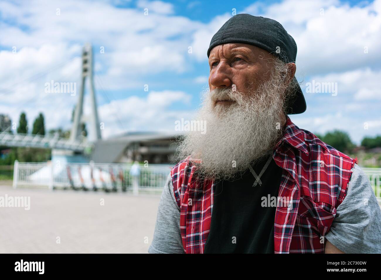 Stylish old man with grey beard outdoors Thoughts on the life of a hipster Stock Photo