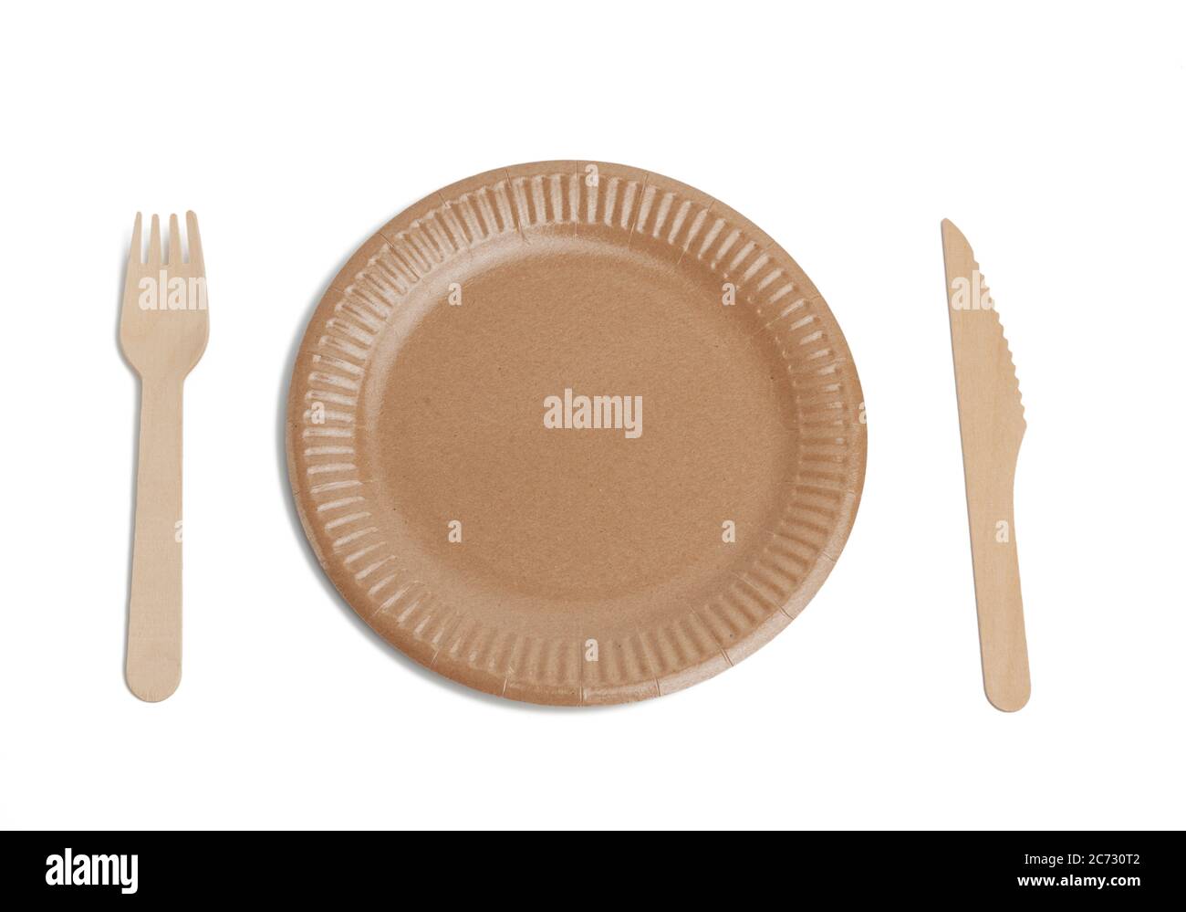 wooden fork, knife and empty round brown disposable plate made from
