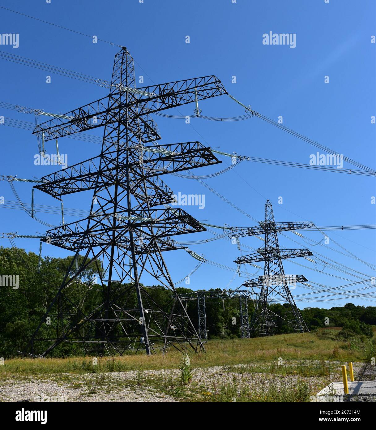 Two electricity plyons near Ninfield Substation in Sussex, England, UK. Stock Photo