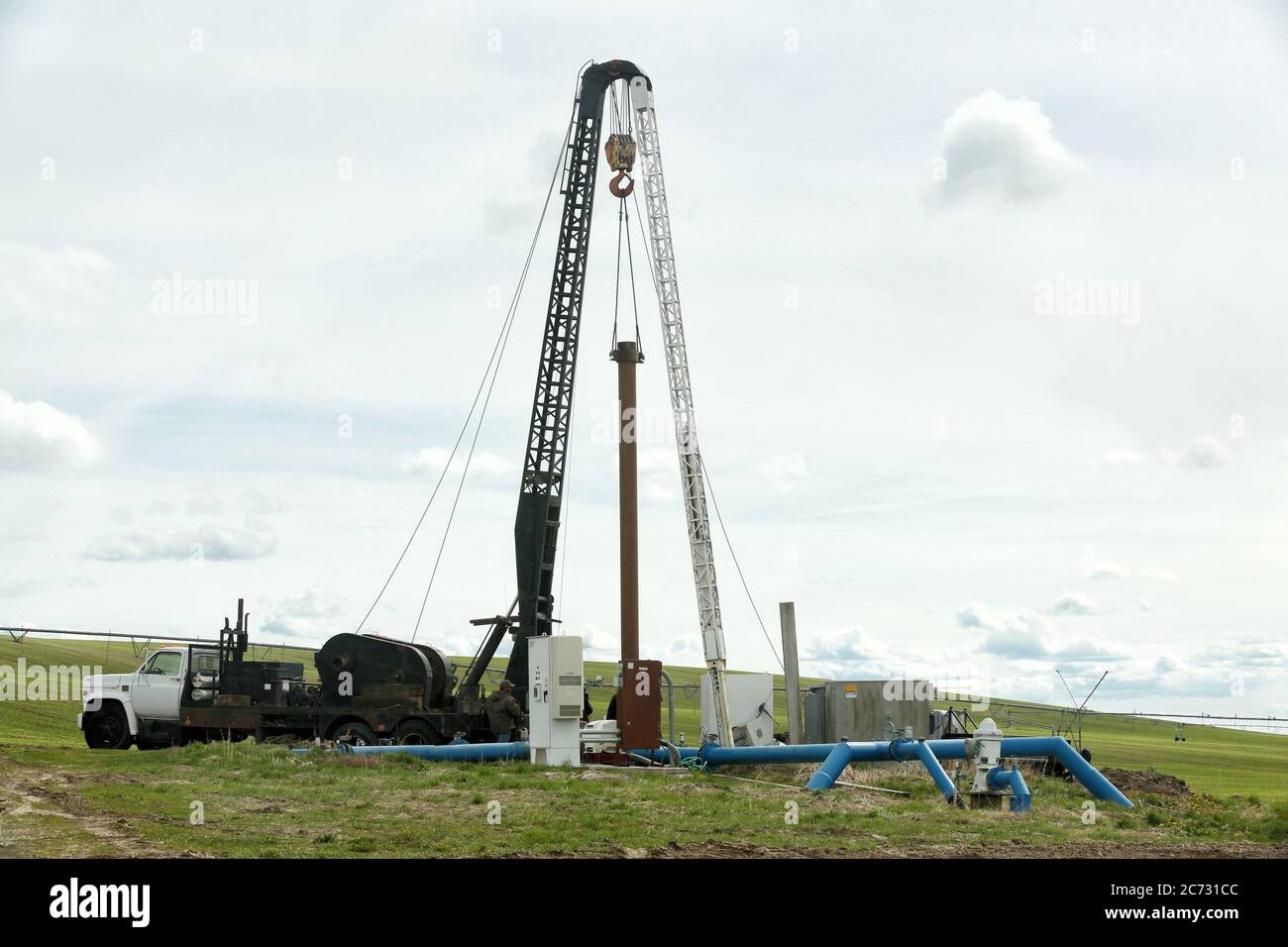 A well drilling rig set up in an Idaho farm field to drill a water well