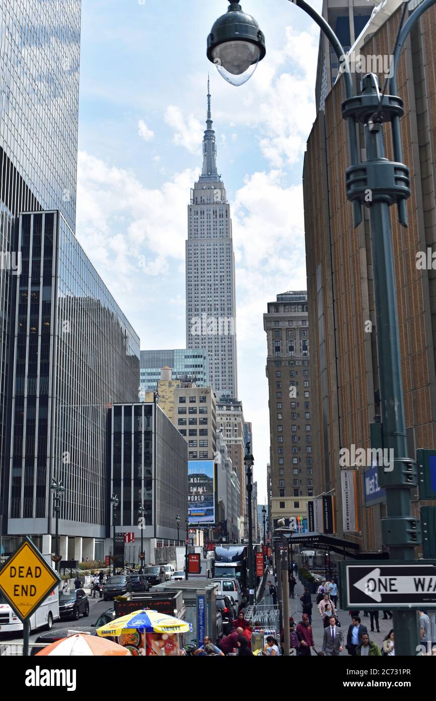 The Empire State Building pictured from a busy street in New York City ...