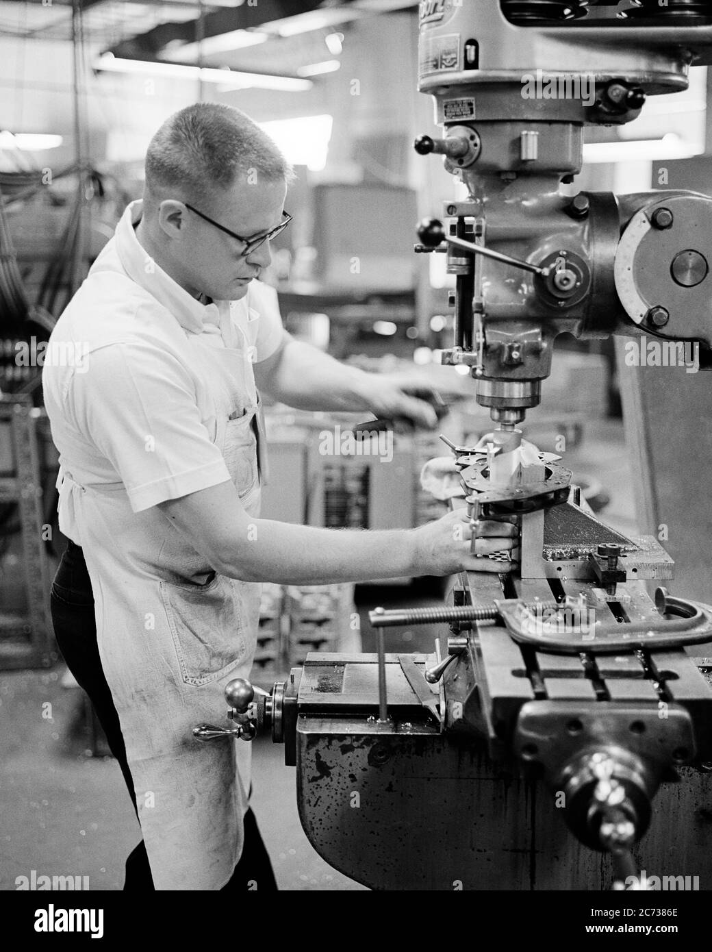 1960s 1970s SKILLED MAN MACHINIST OPERATING A HORIZONTAL MILLING MACHINE IN A MANUFACTURING FACTORY TOOL ROOM SHOP - i5521 HAR001 HARS MALES PROFESSION CONFIDENCE B&W GOALS SKILL OCCUPATION SKILLS OPERATING WELLNESS CUSTOMER SERVICE CAREERS KNOWLEDGE INNOVATION PRIDE A IN OPPORTUNITY EMPLOYMENT MANUFACTURING OCCUPATIONS MOTION BLUR CONCEPTUAL SKILLED EMPLOYEE CREATIVITY MID-ADULT MID-ADULT MAN PRECISION WAGE EARNER BLACK AND WHITE CAUCASIAN ETHNICITY HAR001 MACHINIST MILLING OLD FASHIONED Stock Photo