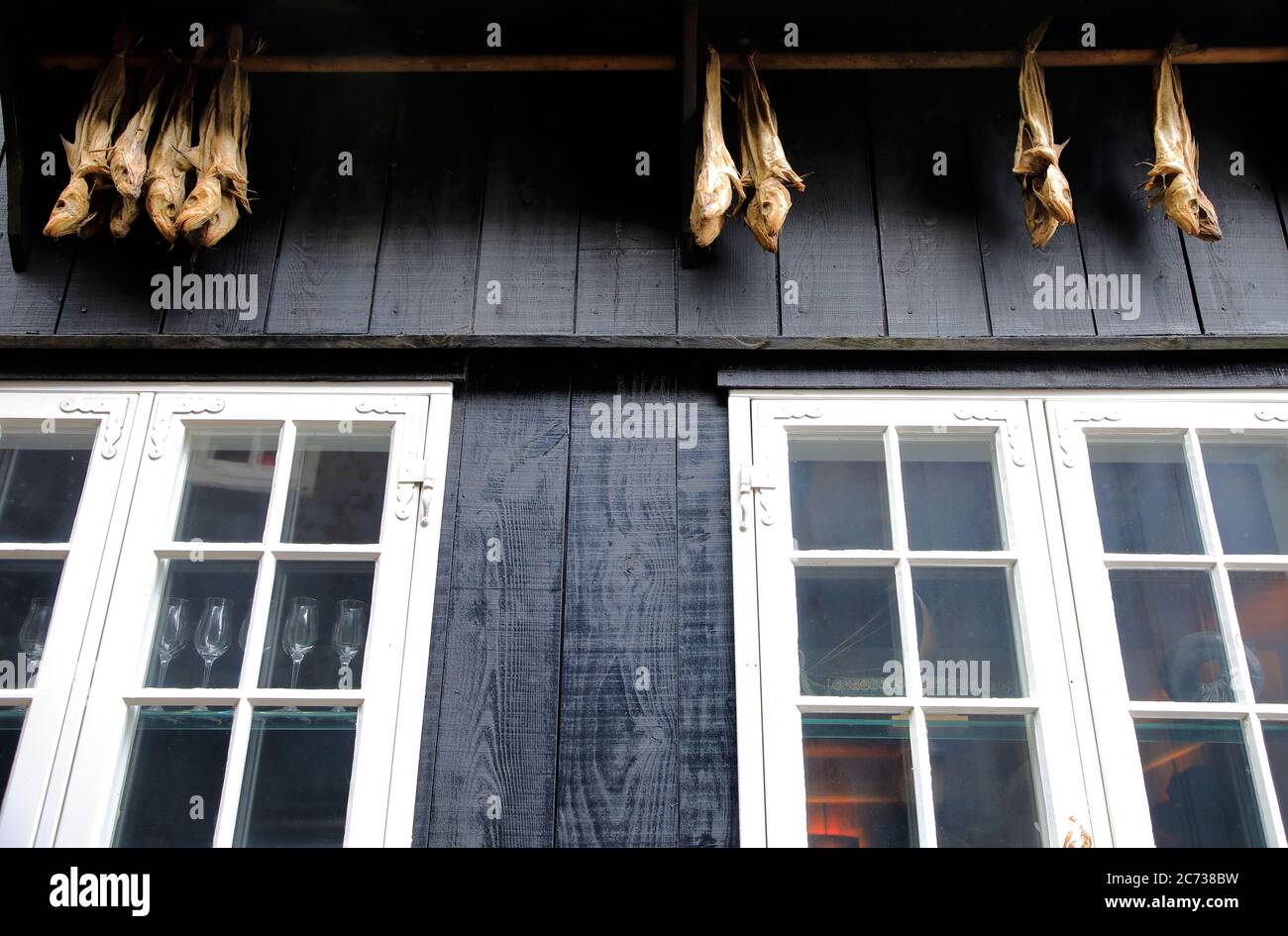 Air dried fishes hanging under roof of a traditional house in Old Town (Tinganes). Torshavn.Streymoy.Faroe Island.Territory of Denmark Stock Photo