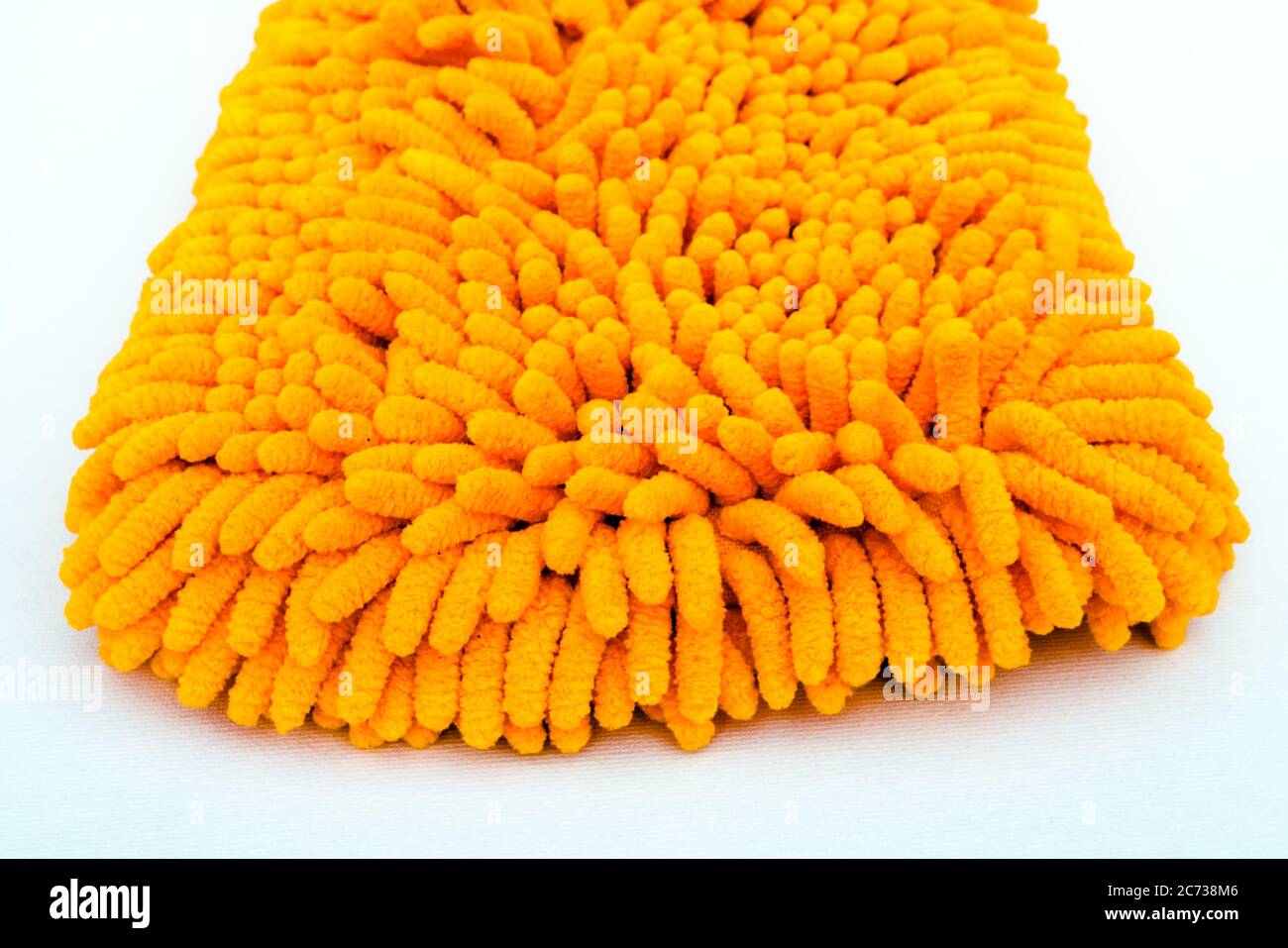 A Studio Photograph of an Orange Microfibre Wash Mitt Stock Photo