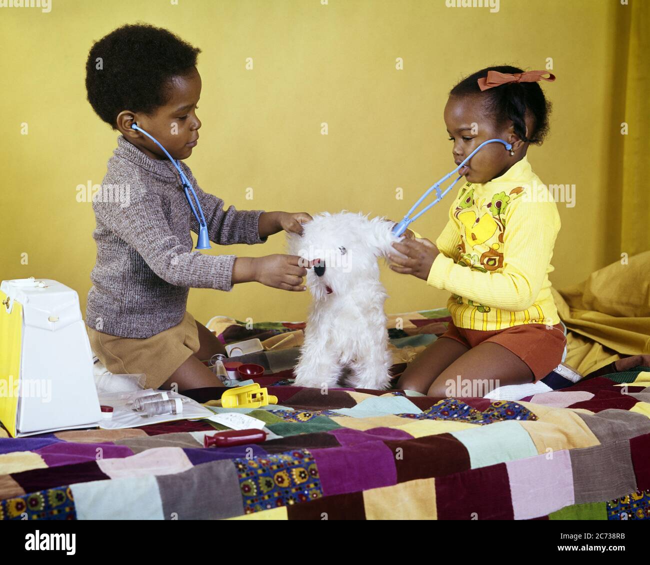 1970s AFRICAN-AMERICAN BOY AND GIRL BROTHER AND SISTER PLAYING VETERINARIAN DOCTOR WITH TOY STETHOSCOPE AND STUFFED ANIMAL DOG - kj5029 PHT001 HARS HOME LIFE COPY SPACE FRIENDSHIP HALF-LENGTH INSPIRATION MALES SIBLINGS SISTERS STETHOSCOPE DREAMS MAMMALS HEALING AFRICAN-AMERICANS AFRICAN-AMERICAN AND CANINES BLACK ETHNICITY OCCUPATIONS SIBLING POOCH CONNECTION CONCEPTUAL TREATING VETERINARIAN ANONYMOUS CANINE COOPERATION GROWTH JUVENILES MAMMAL TOGETHERNESS OLD FASHIONED AFRICAN AMERICANS Stock Photo