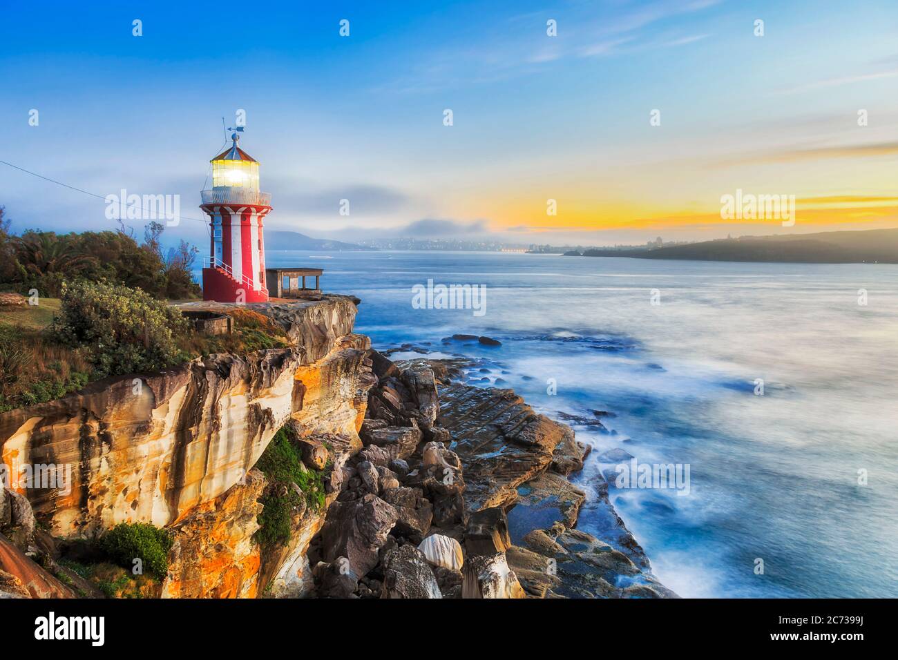 Hornby lighthouse at sunrise on South head of Sydney - edge of sandstone cliff facing Pacific ocean. Stock Photo