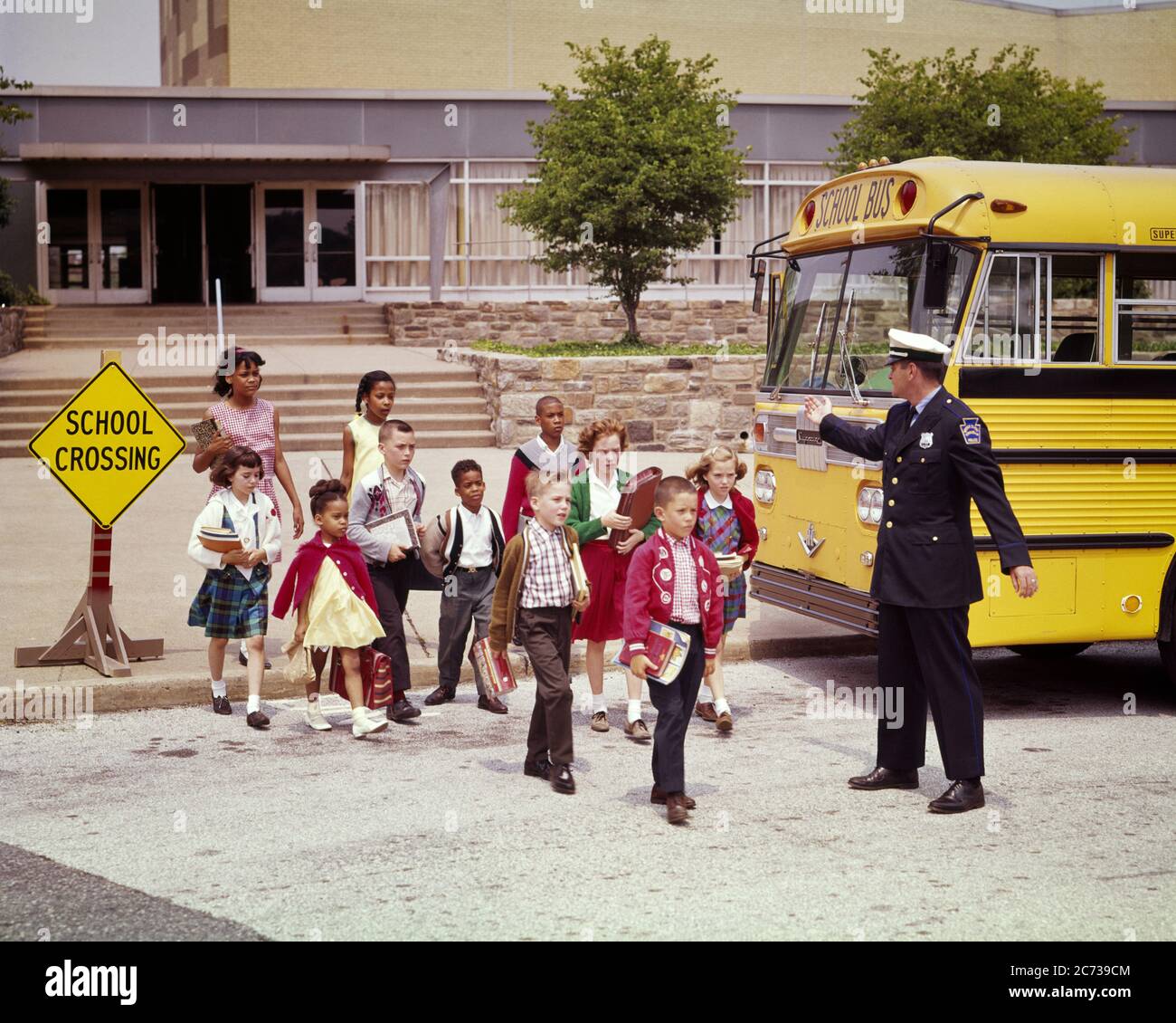 1960s GROUP OF ETHNICALLY MIXED KIDS BOY AND GIRLS CROSSING STREET IN SCHOOL CROSSING WITH TRAFFIC POLICEMAN AND SCHOOL BUS - ks3114 HAR001 HARS POLICEMAN JUVENILE ELEMENTARY SECURITY SAFETY PUBLIC TEAMWORK LIFESTYLE FEMALES COPY SPACE FULL-LENGTH PERSONS CARING MALES RISK OFFICER CONFIDENCE TRANSPORTATION MIXED COP PROTECT AND SERVE SCHOOLS GRADE HIGH ANGLE PROTECTION STRENGTH MOTOR VEHICLE ZONE AFRICAN-AMERICANS AFRICAN-AMERICAN AND BLACK ETHNICITY DIRECTION IN OF OCCUPATIONS PRIMARY UNIFORMS OFFICERS POLICEMEN BUSES COPS ETHNICALLY GRADE SCHOOL JUVENILES TOGETHERNESS TRANSIT BADGE BADGES Stock Photo