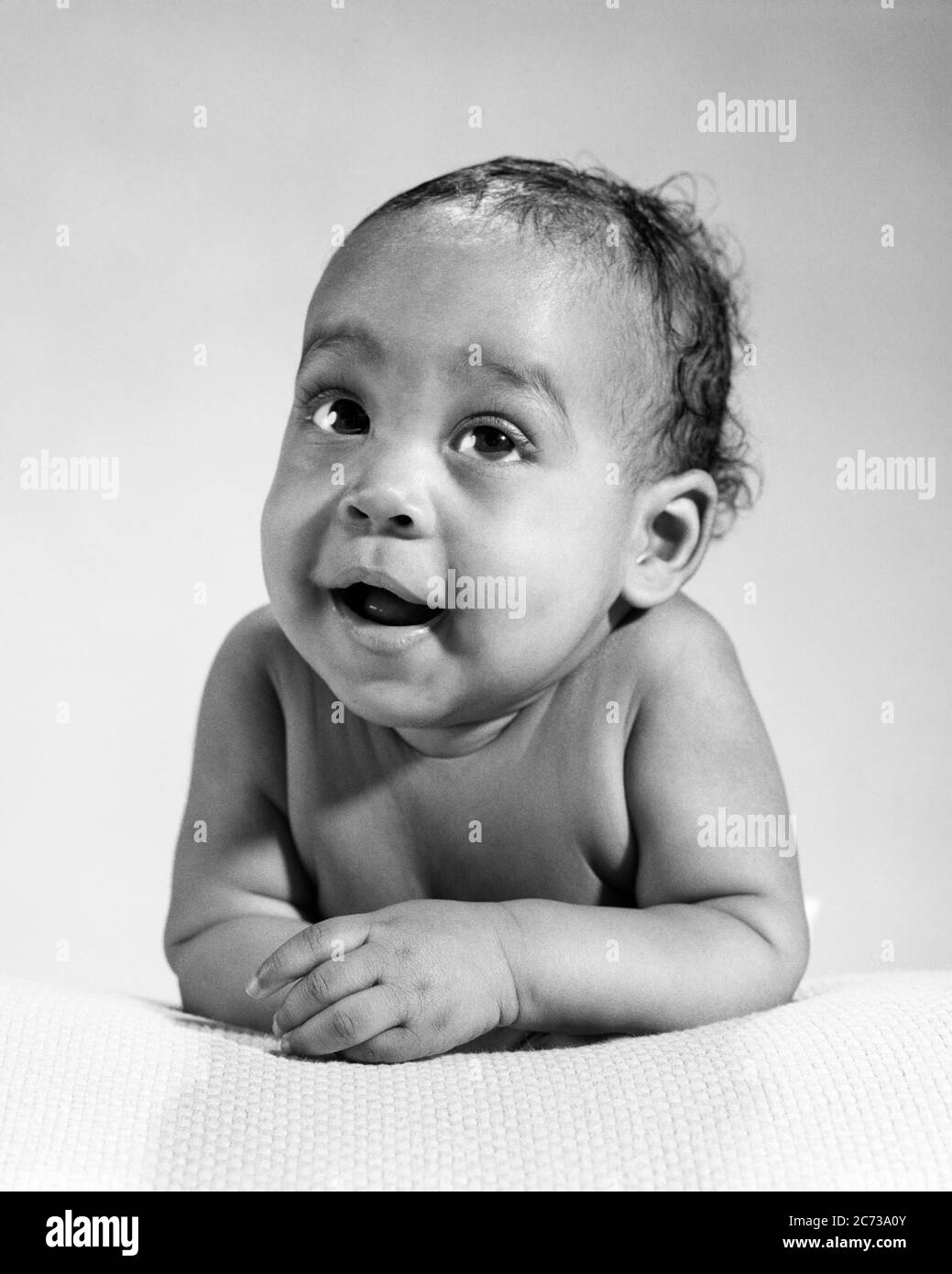 1960s AFRICAN-AMERICAN BABY ARMS FOLDED IN FRONT LOOKING AT CAMERA DIRECTLY - n2311 HAR001 HARS EXPRESSIONS B&W EYE CONTACT HAPPINESS WELLNESS HEAD AND SHOULDERS AFRICAN-AMERICANS AFRICAN-AMERICAN BLACK ETHNICITY PRIDE DIRECTLY CONNECTION CONCEPTUAL BABY BOY GROWTH JUVENILES BLACK AND WHITE HAR001 OLD FASHIONED AFRICAN AMERICANS Stock Photo