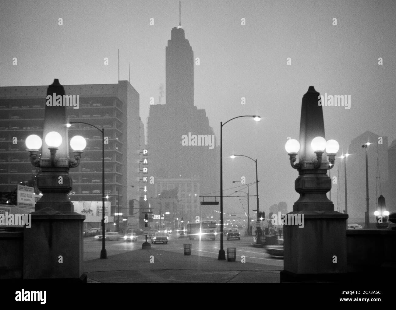 1960s OBELISK LAMPPOSTS ON WACKER DRIVE DOWNTOWN TRAFFIC ON FOGGY NIGHT ALONG CHICAGO RIVER CHICAGO ILLINOIS USA  - r20452 HAR001 HARS MIST VEHICLES EDIFICE ILLINOIS BLACK AND WHITE HAR001 IL LAMPPOSTS MIDWEST MIDWESTERN OBELISK OLD FASHIONED Stock Photo